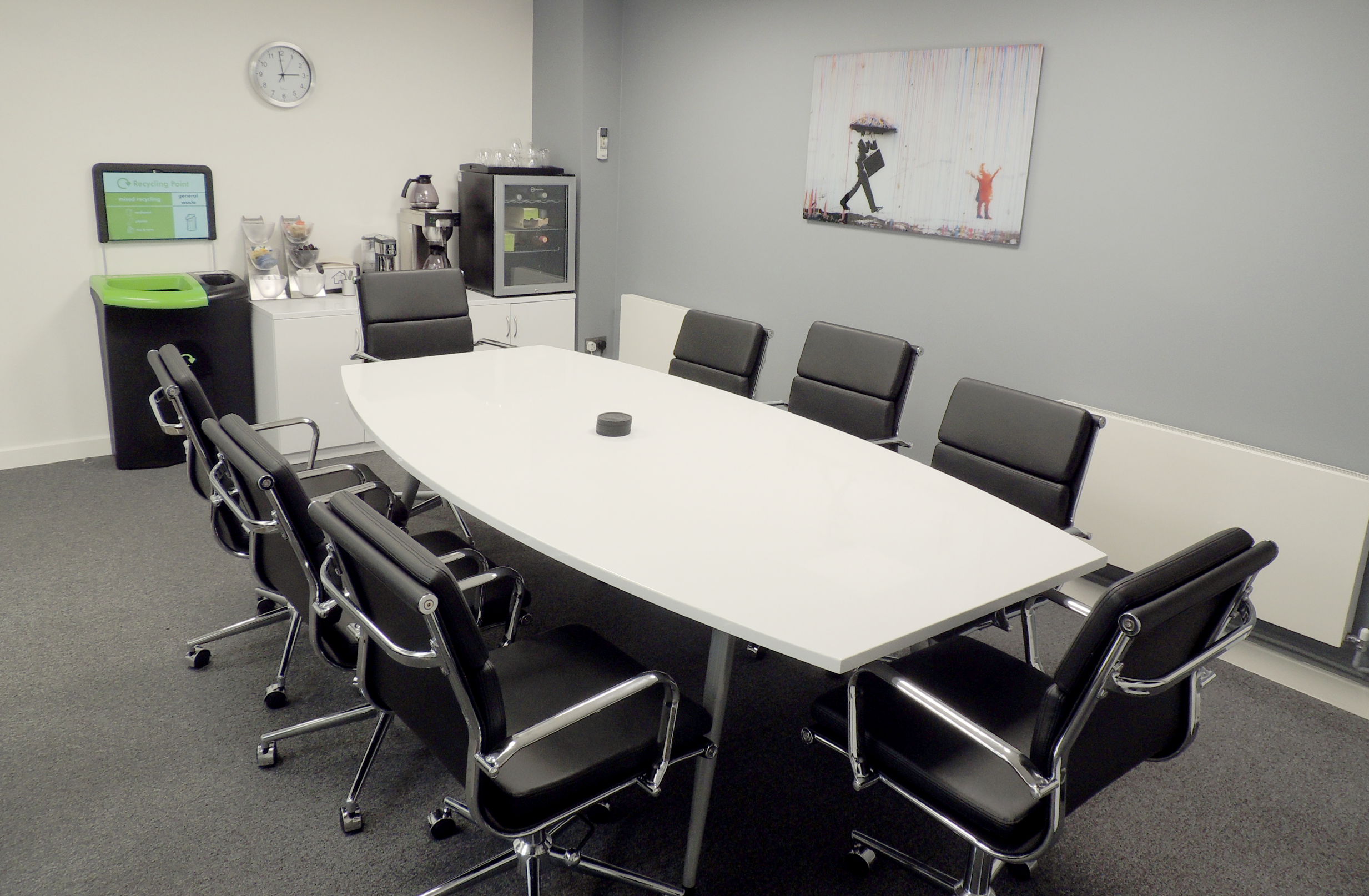 Modern conference room with oval table and ergonomic chairs for effective meetings.