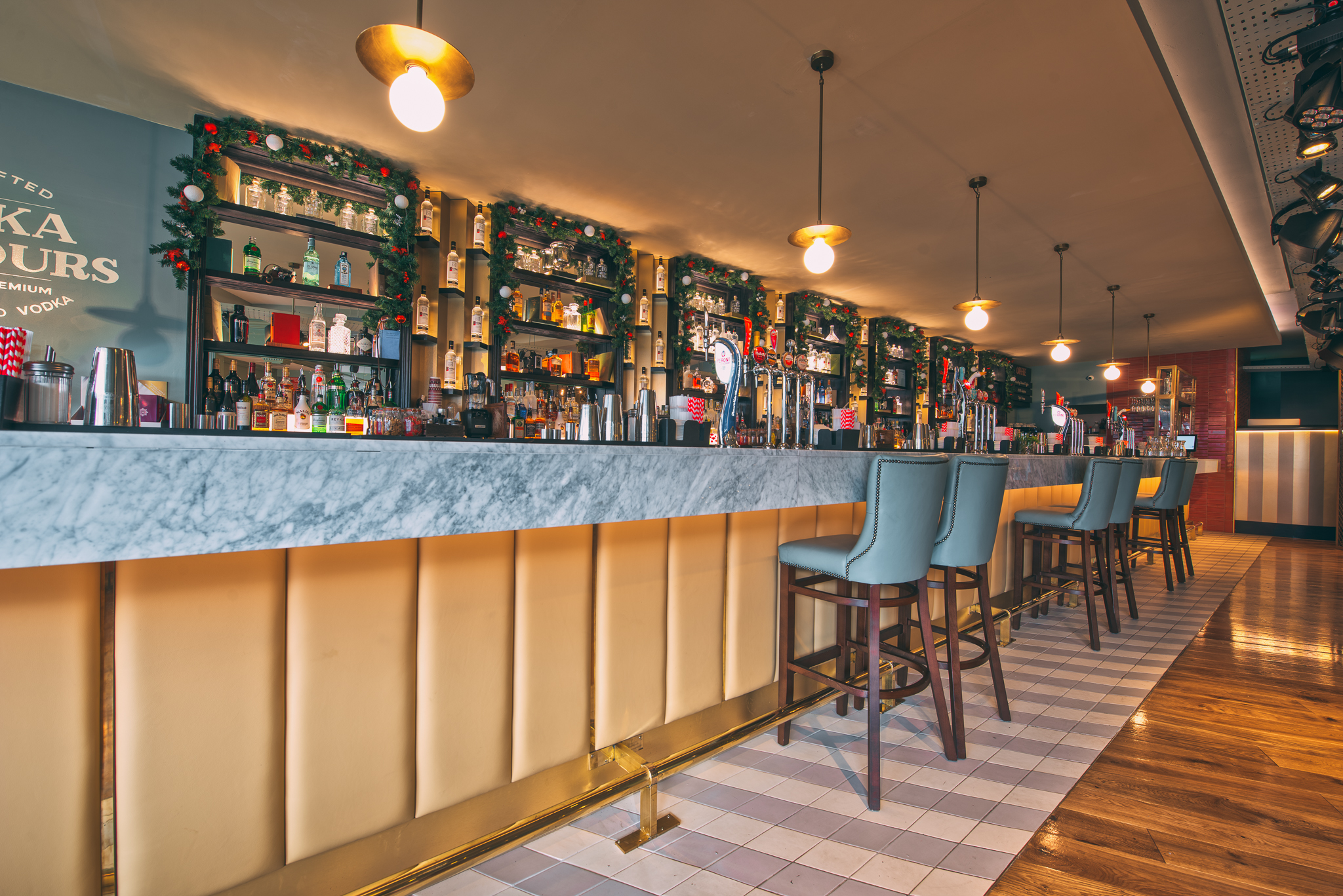 Stylish bar area with marble countertop for networking events at Revolution Solihull.