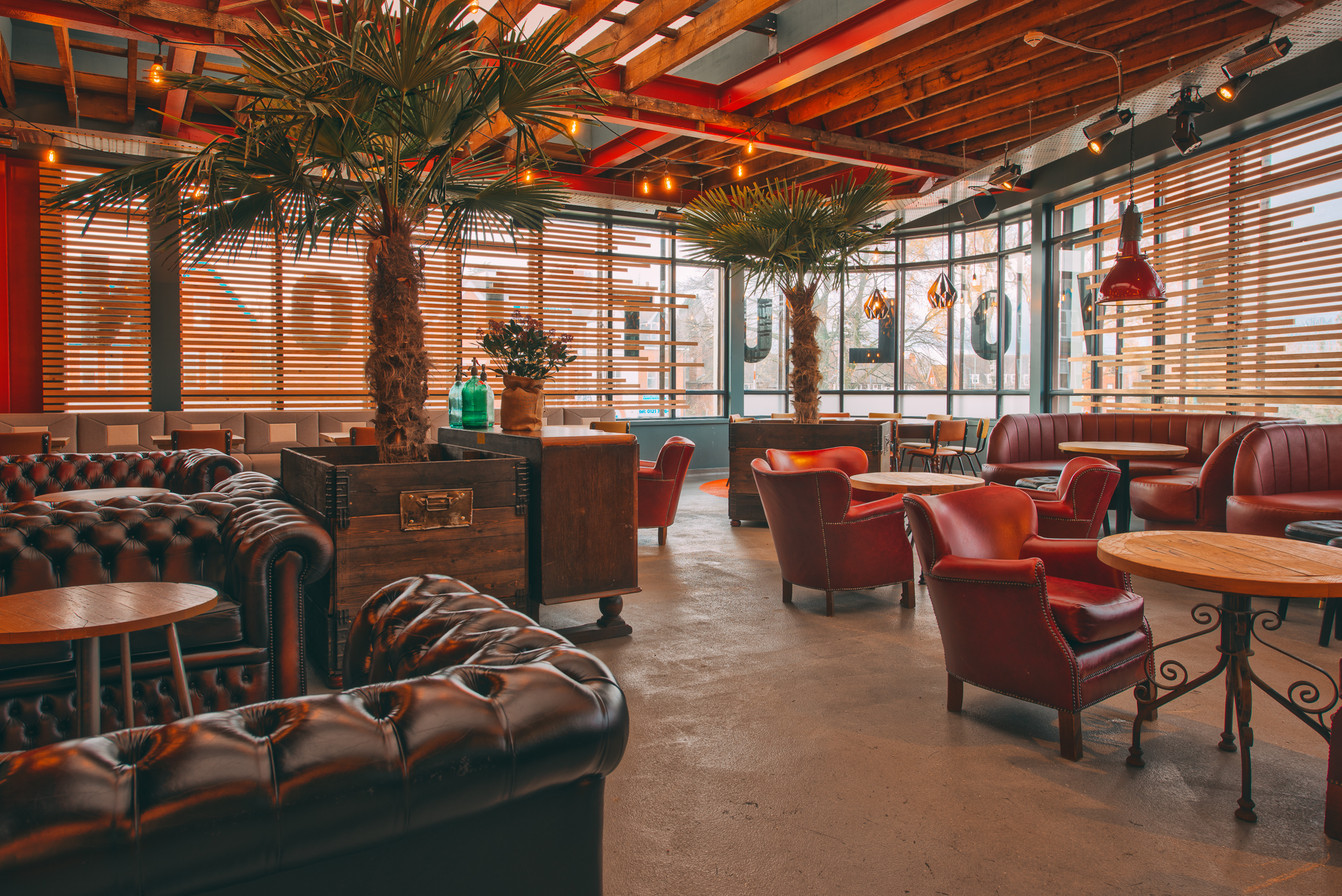 Stylish lounge area with leather seating for networking events at Revolution Solihull.