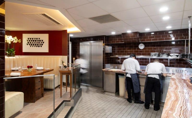 Modern kitchen table in Petrus, perfect for culinary events and private dining.