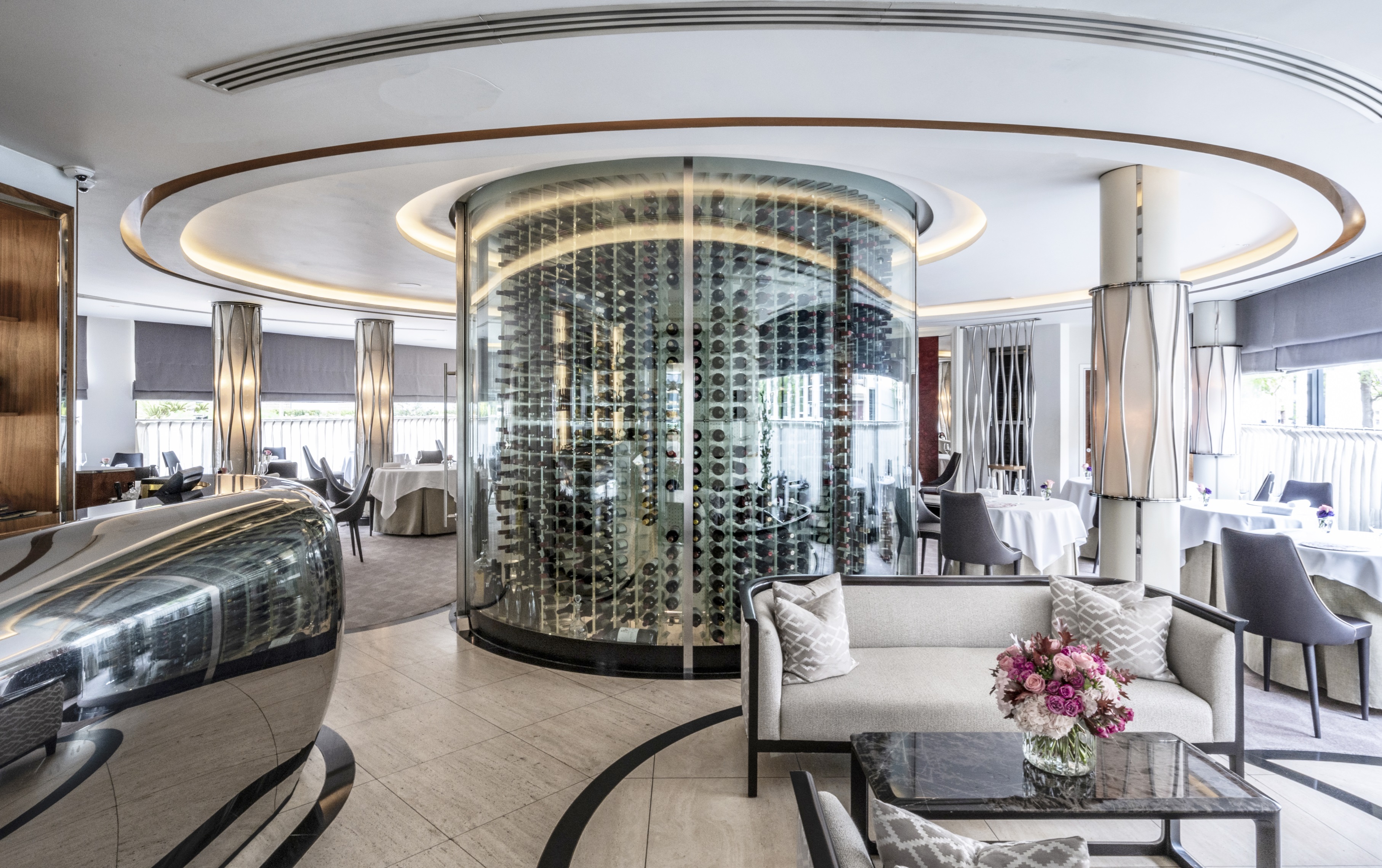 Sophisticated dining space with glass wine display for upscale events in Petrus.