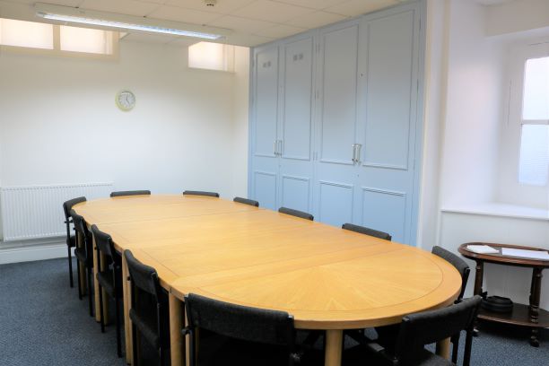 Spacious Marie-Louise Room with oval table, ideal for meetings and presentations.