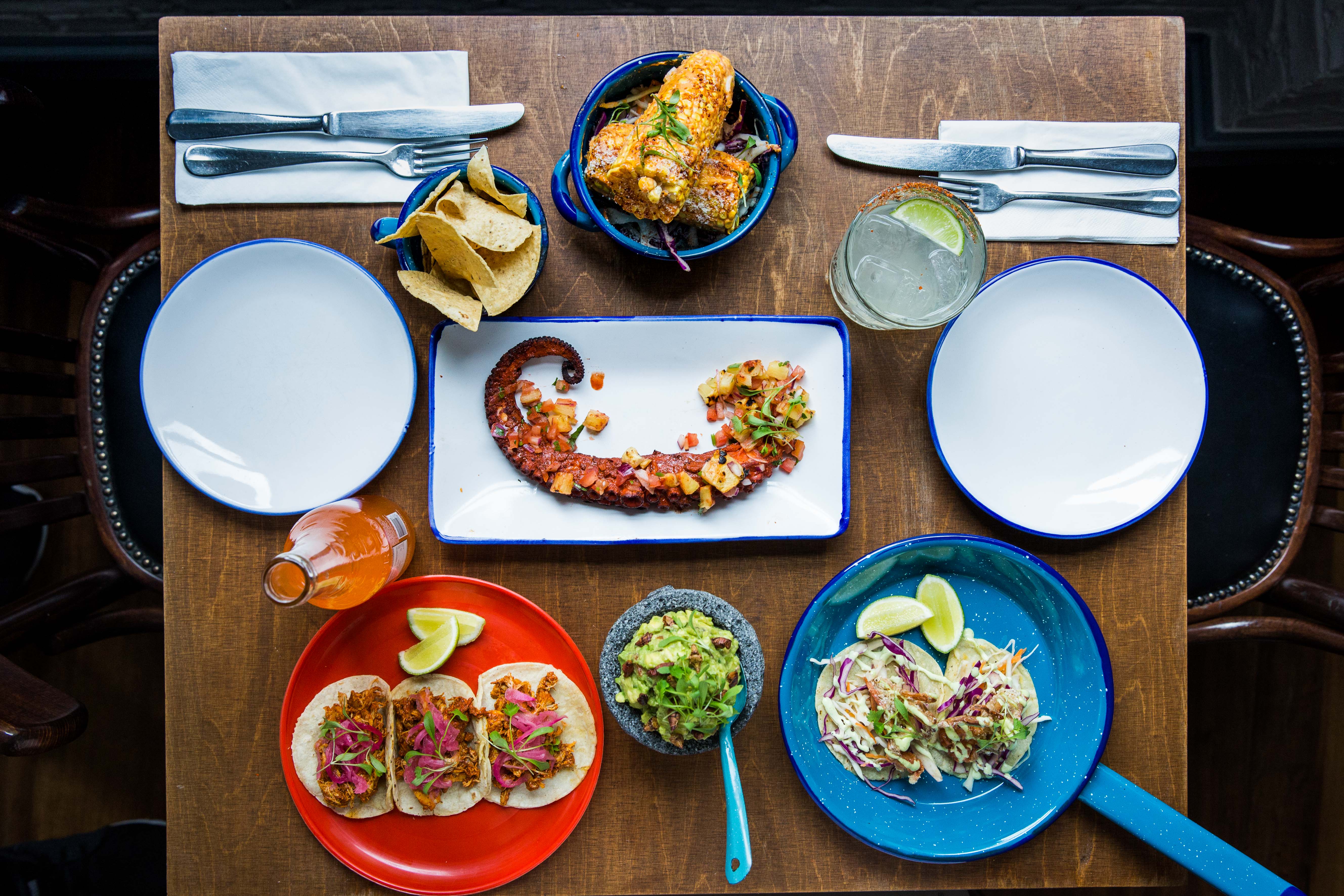 Vibrant Agave Dining Room table set for a festive culinary event with colorful dishes.