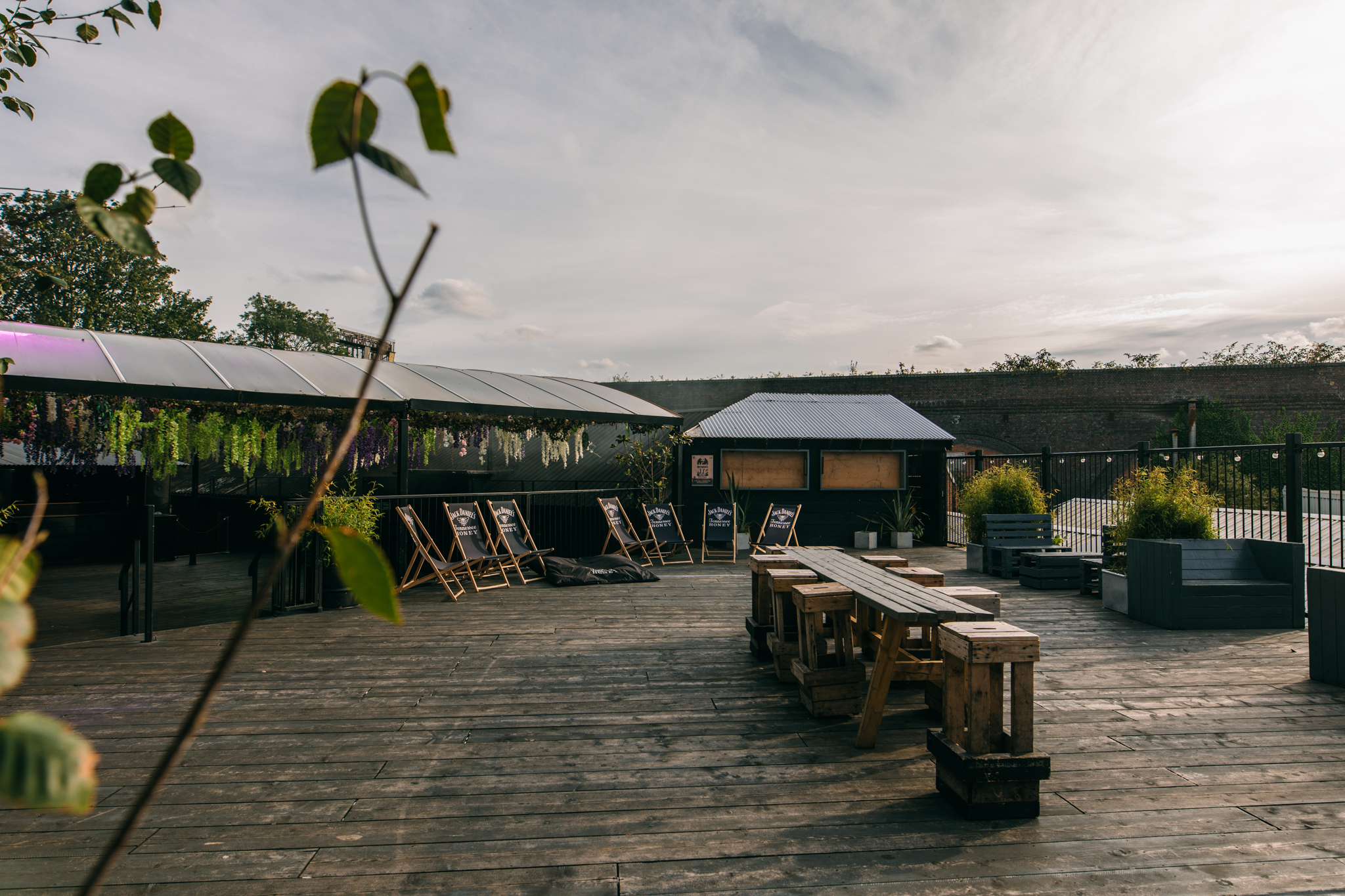 Roof Terrace at XOYO Birmingham, outdoor event space with rustic wooden seating.