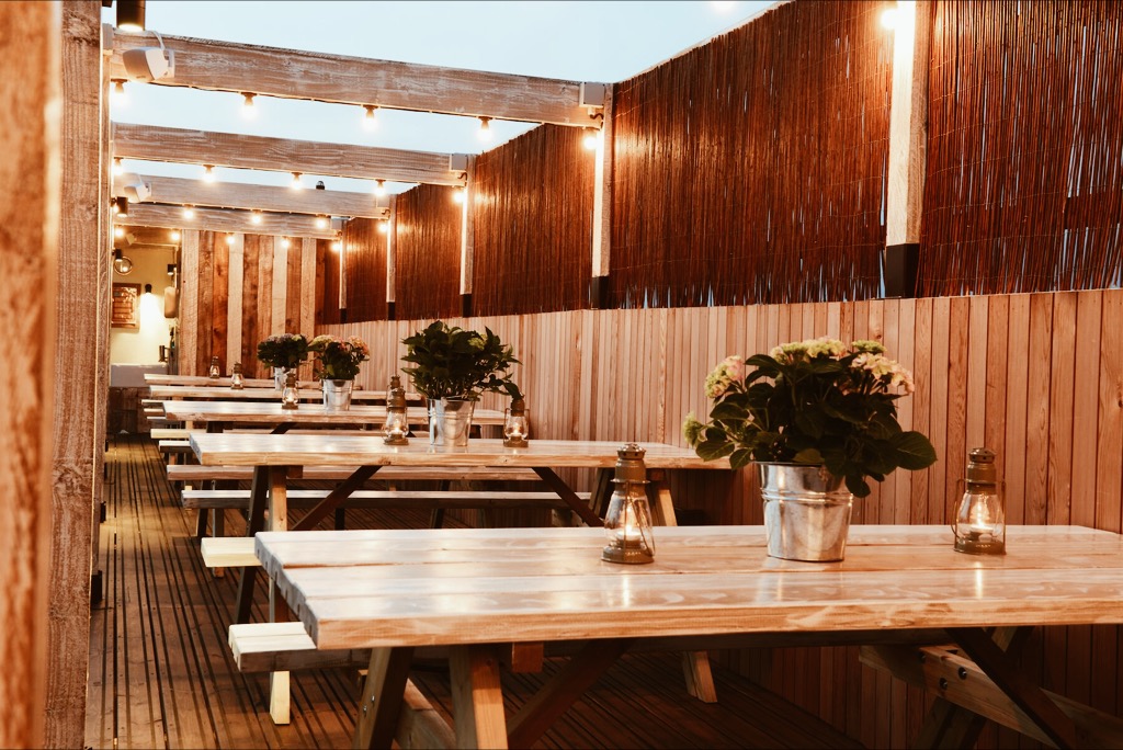 Chiswick Roof Terrace with rustic tables, ideal for networking events and celebrations.