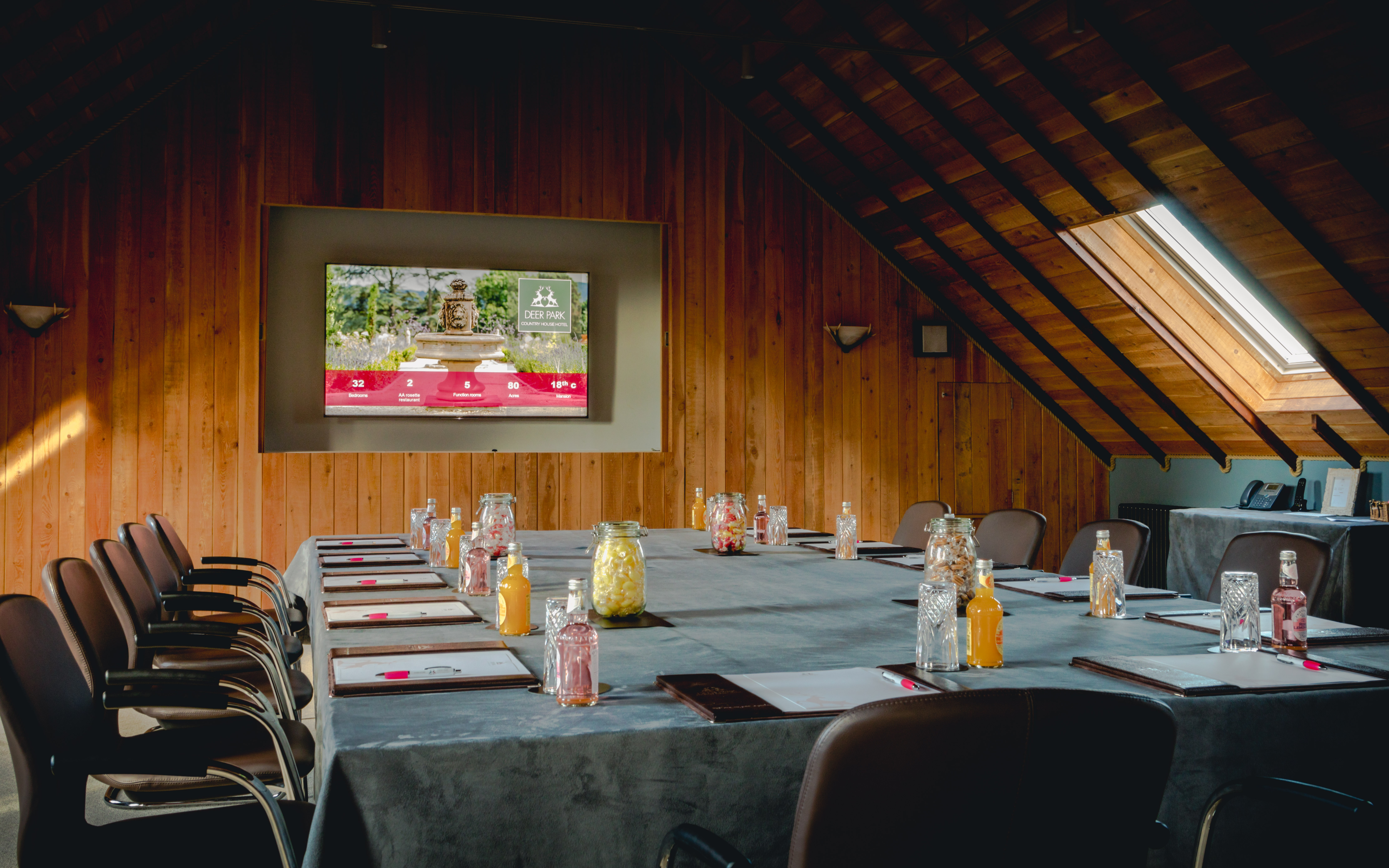 Motor House Meeting Room with long table, ideal for conferences and events.