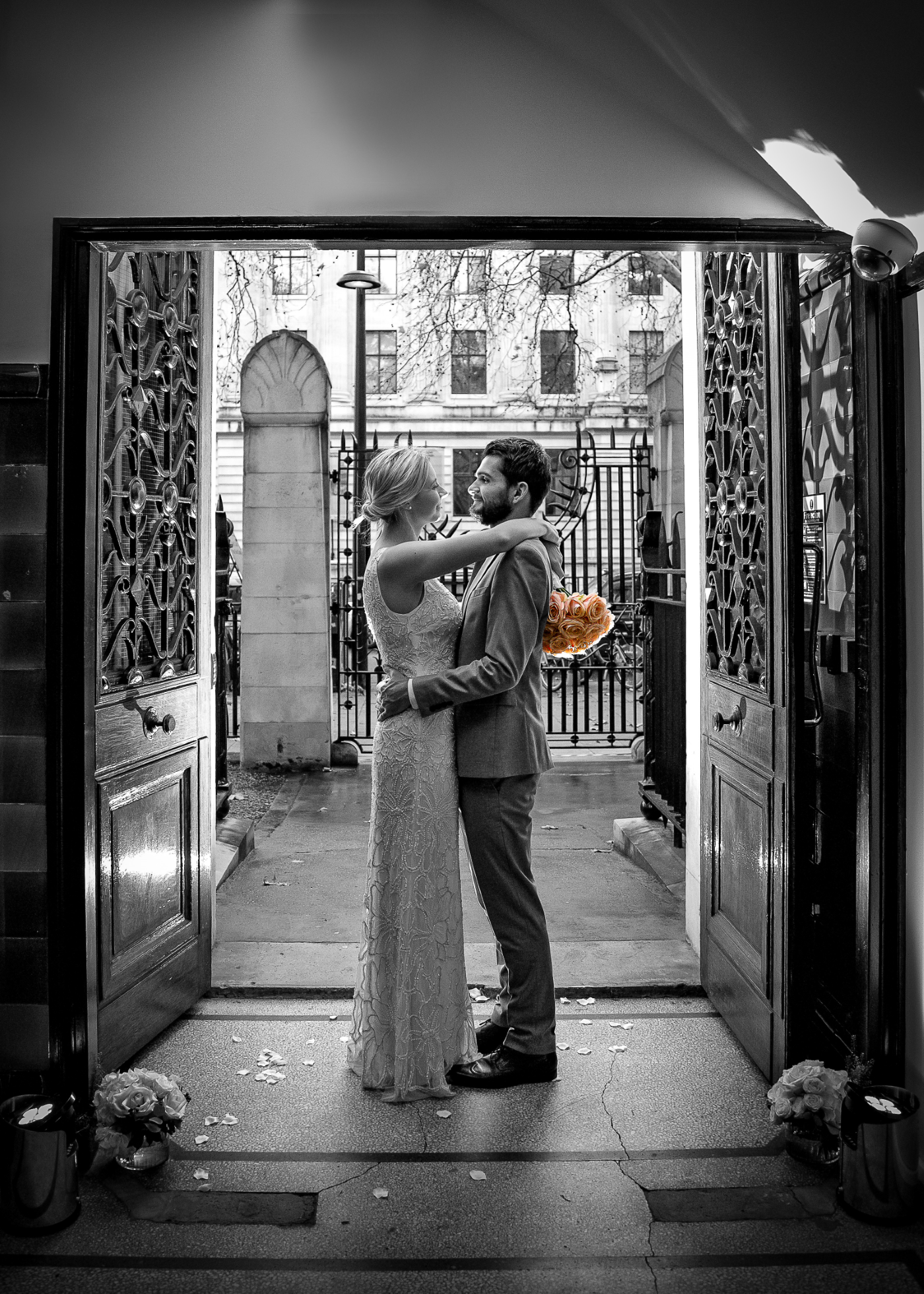 Couple embracing in doorway at elegant wedding in Penthouse State Rooms, 30 Euston Square.