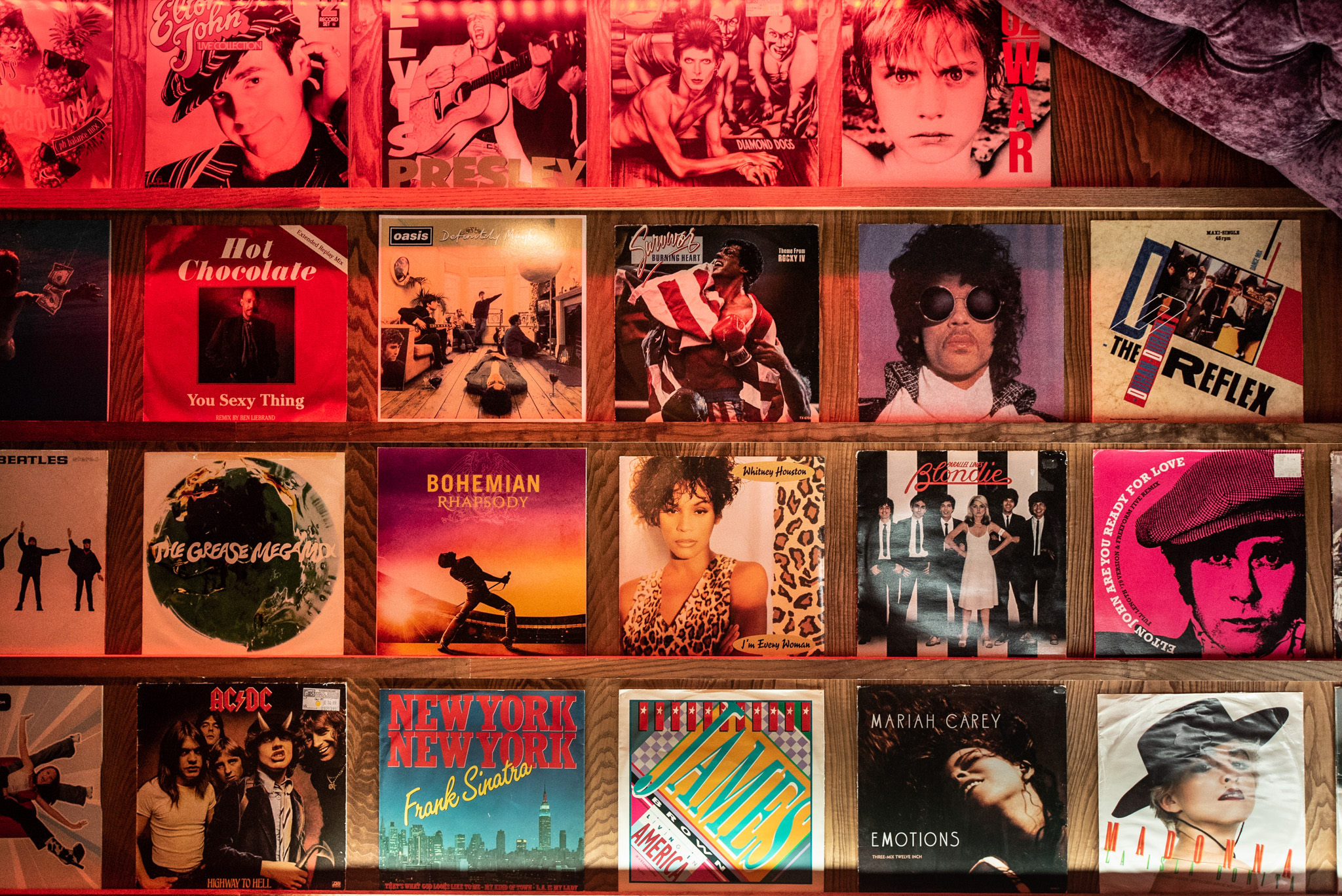 Private karaoke room with vibrant vinyl records for retro music events and networking.