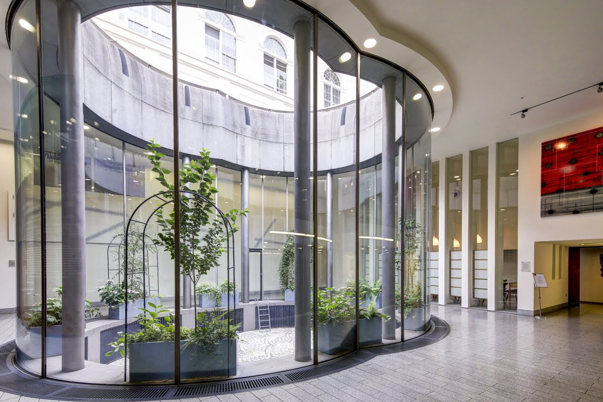 St Martins Hall atrium with glass walls, perfect for networking events and meetings.
