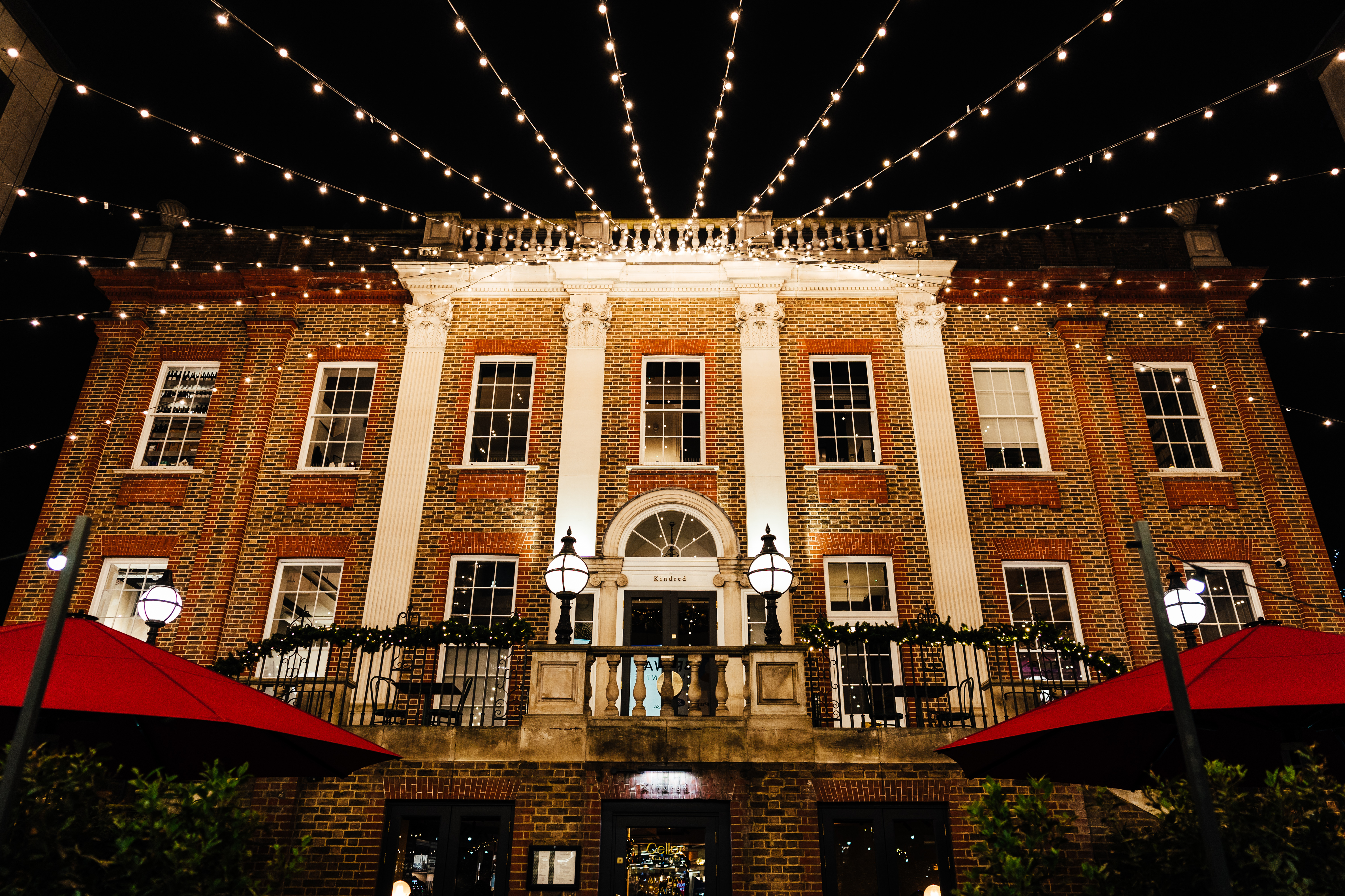 Charming outdoor library venue with string lights for evening events and receptions.