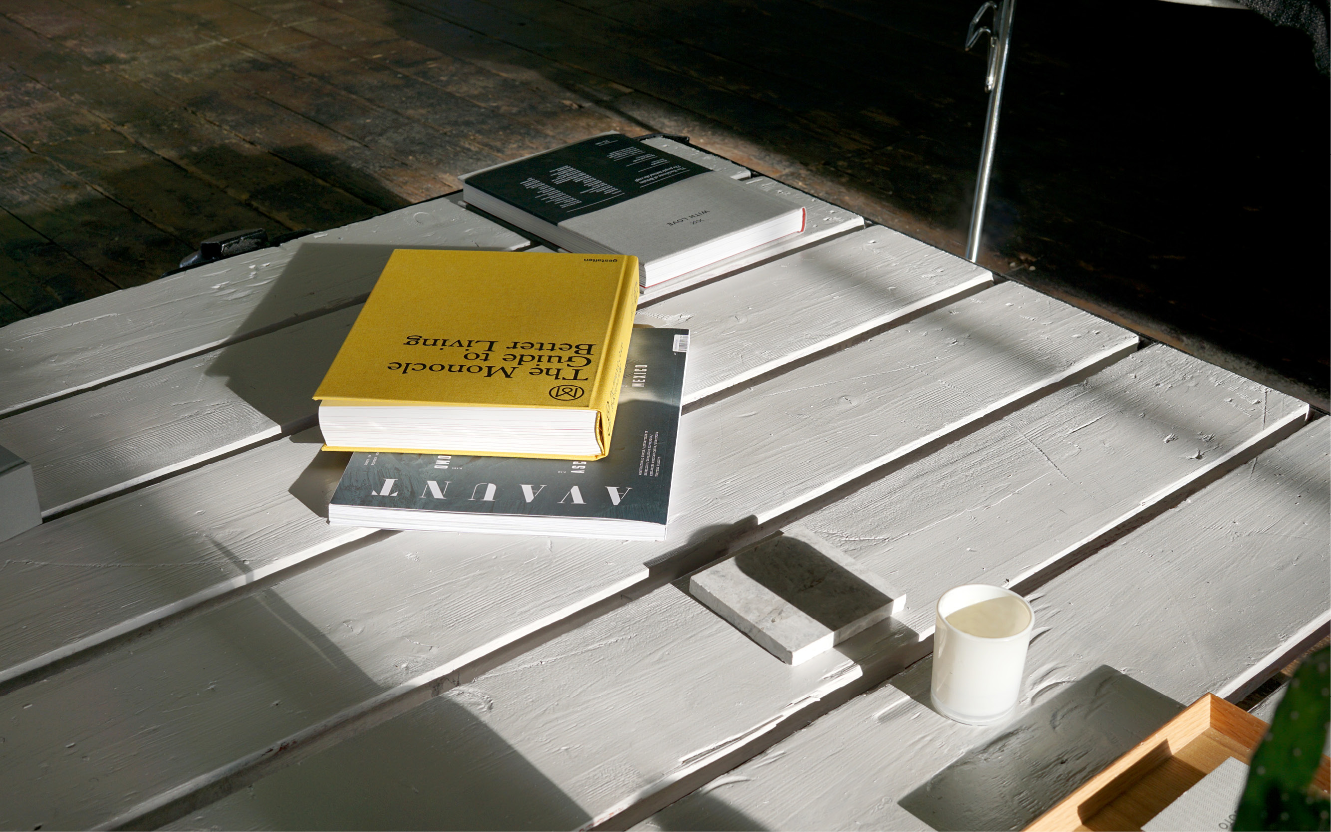 Stylish minimalist meeting space with whitewashed table for creative events.