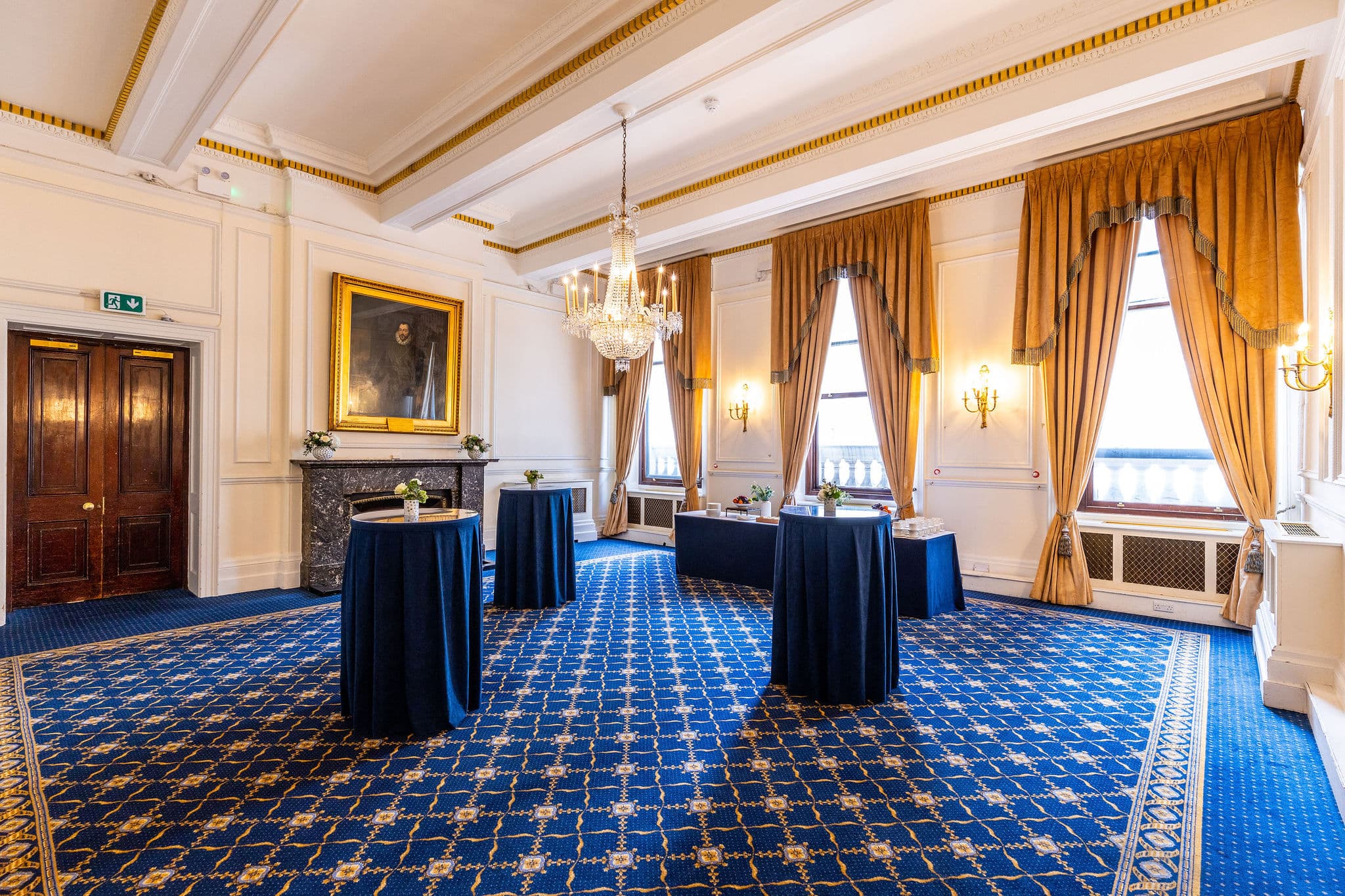 Trafalgar Rooms at 116 Pall Mall with navy poseur tables for cocktail reception event hire.