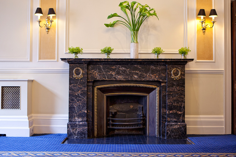 Elegant Trafalgar Rooms event space with fireplace, perfect for networking and gatherings.