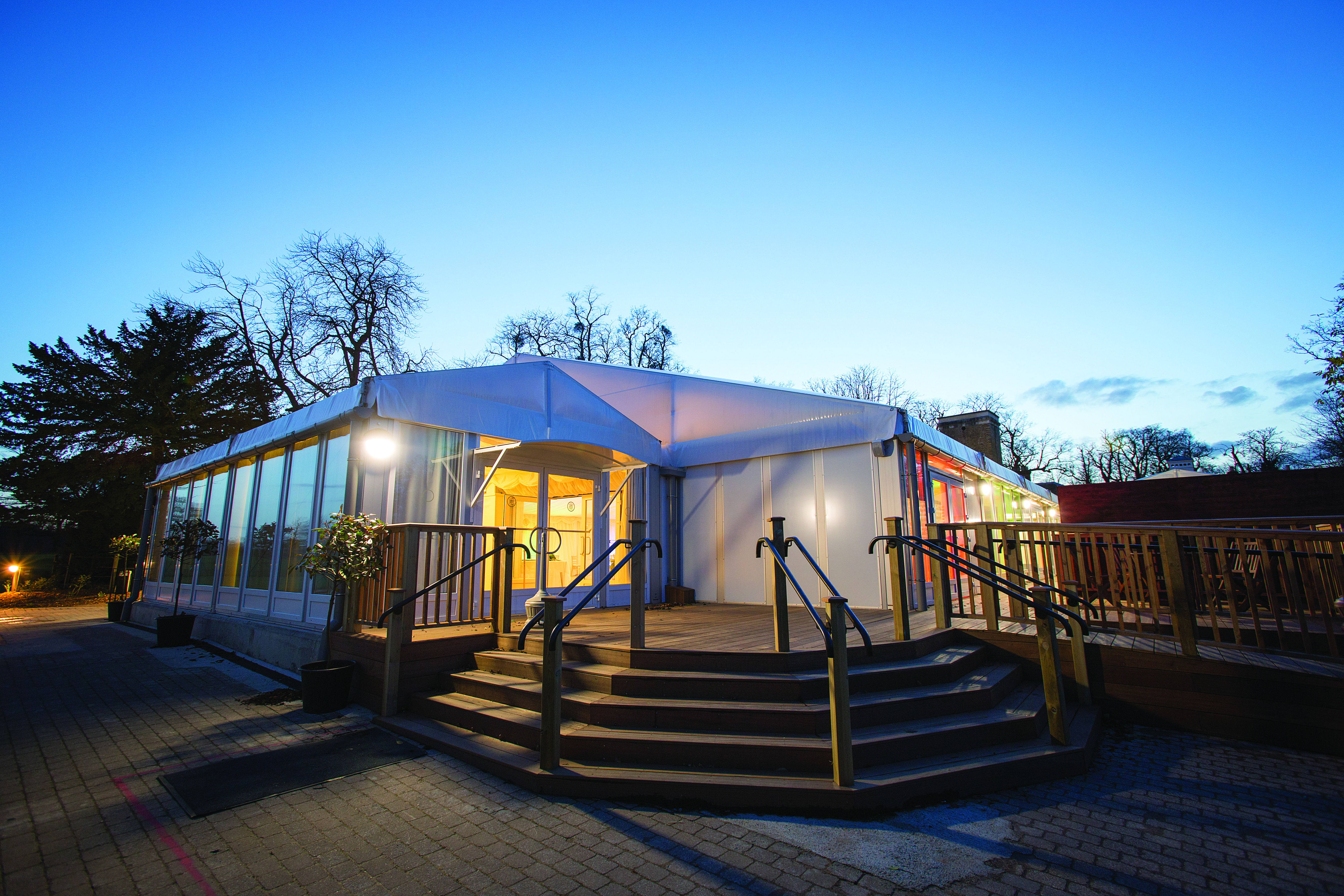 Grand Pavilion at Hylands Estate, modern tent with clear walls for outdoor events.