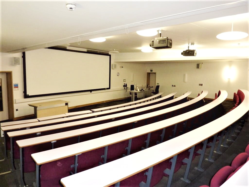 Modern lecture hall with tiered seating for conferences and workshops in Cambridge.