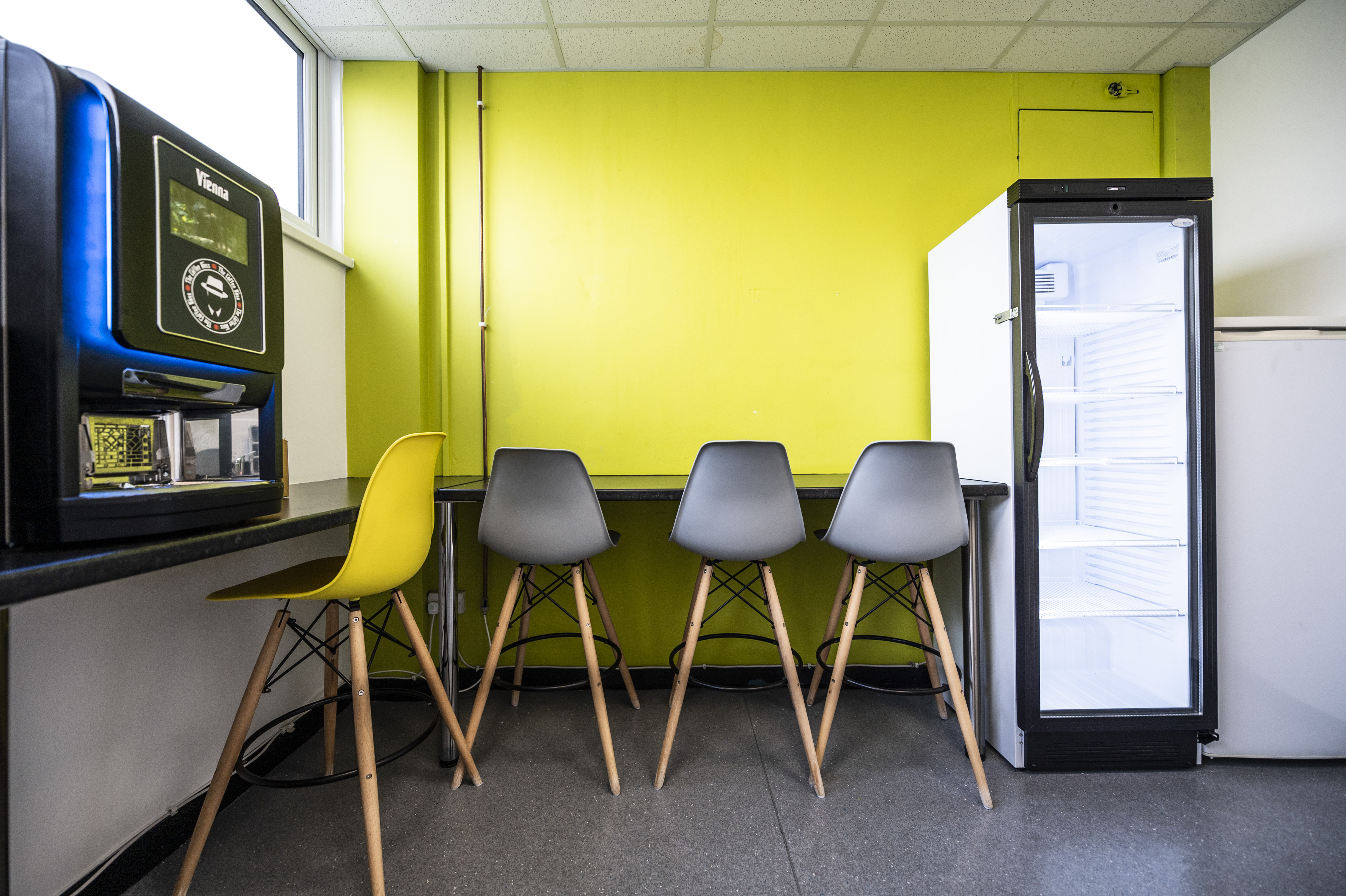Modern meeting room with vibrant green wall for events and networking at Liverpool Film Studios.