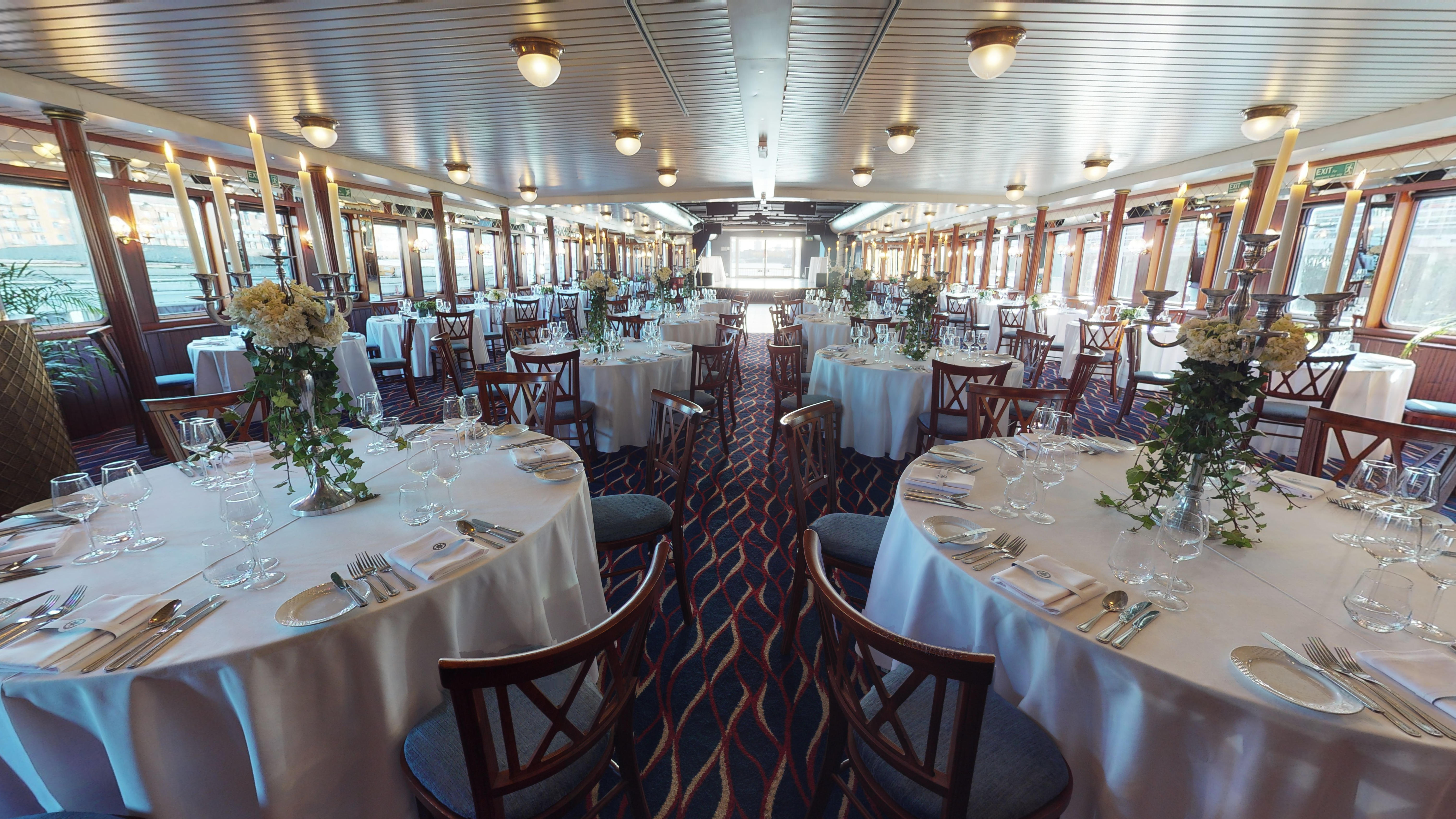 Elegant event space with round tables, ideal for upscale gatherings and celebrations.