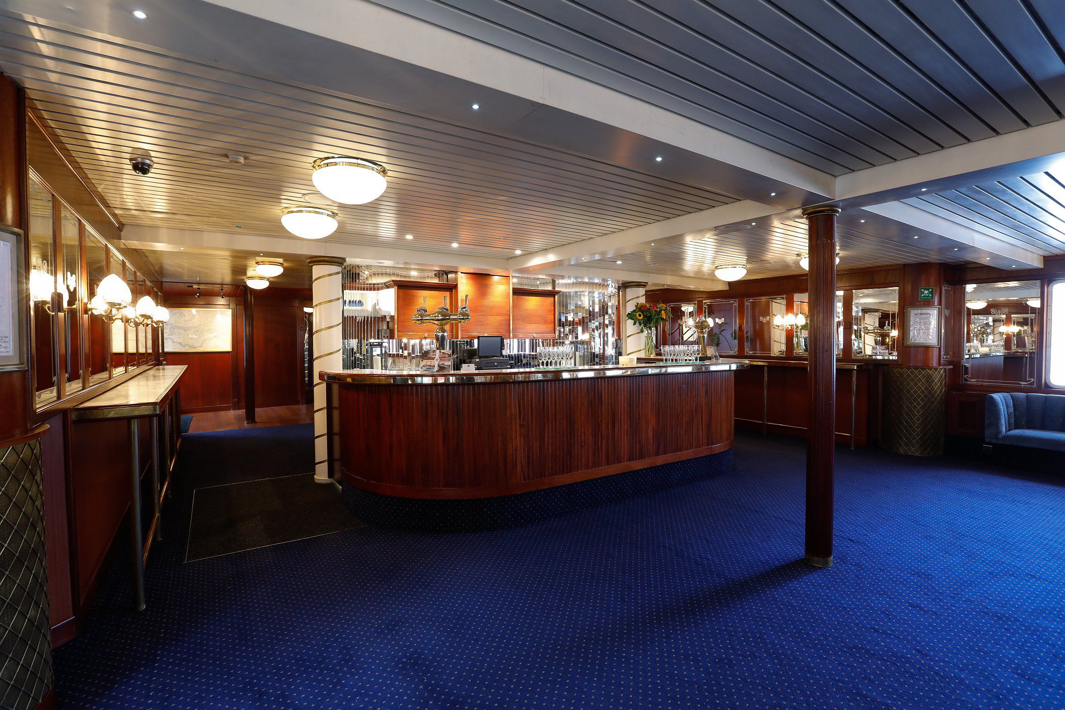 Elegant event space in Dixie Queen with polished wooden bar, ideal for corporate gatherings.