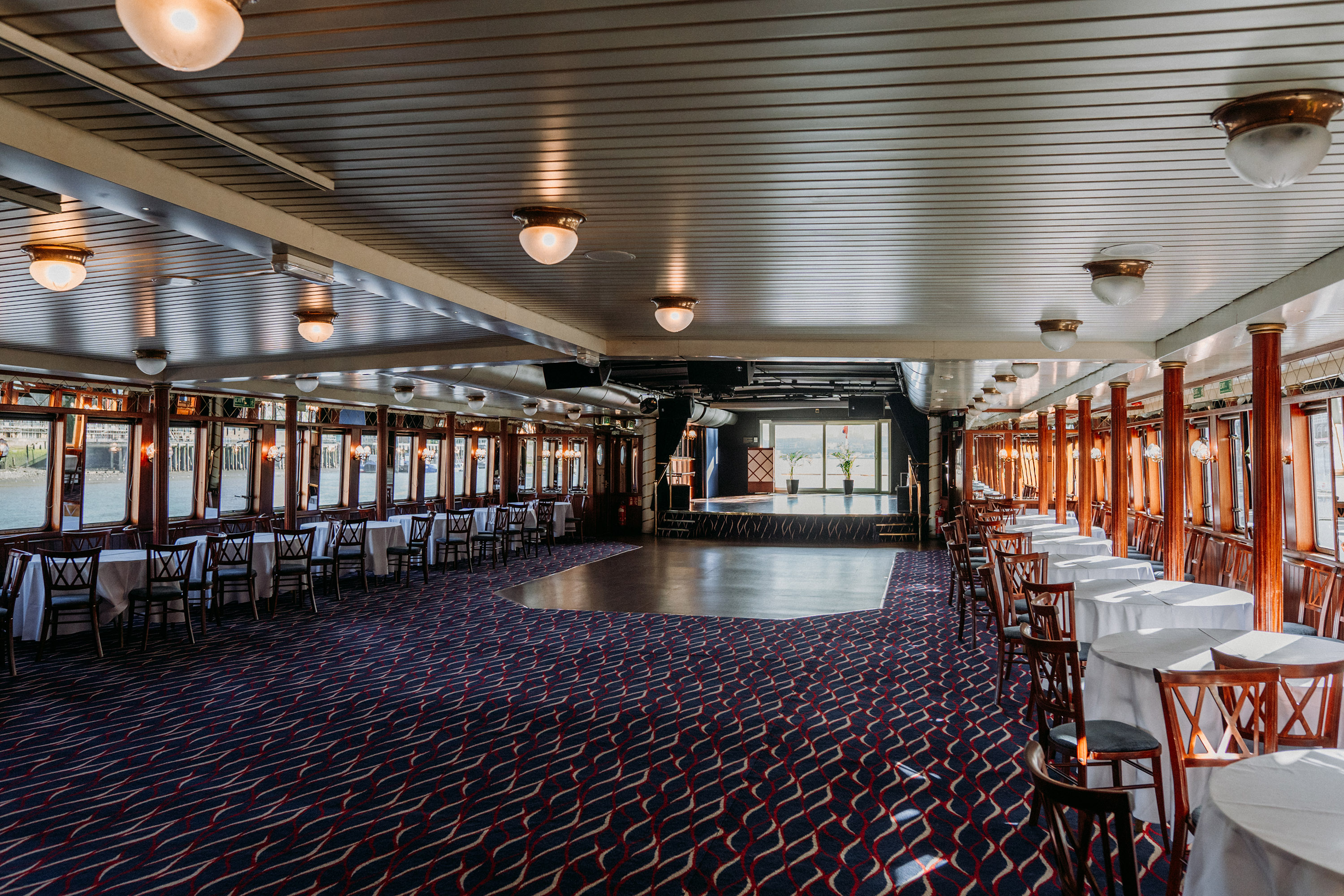 Spacious event venue with elegant decor, ideal for receptions and celebrations.