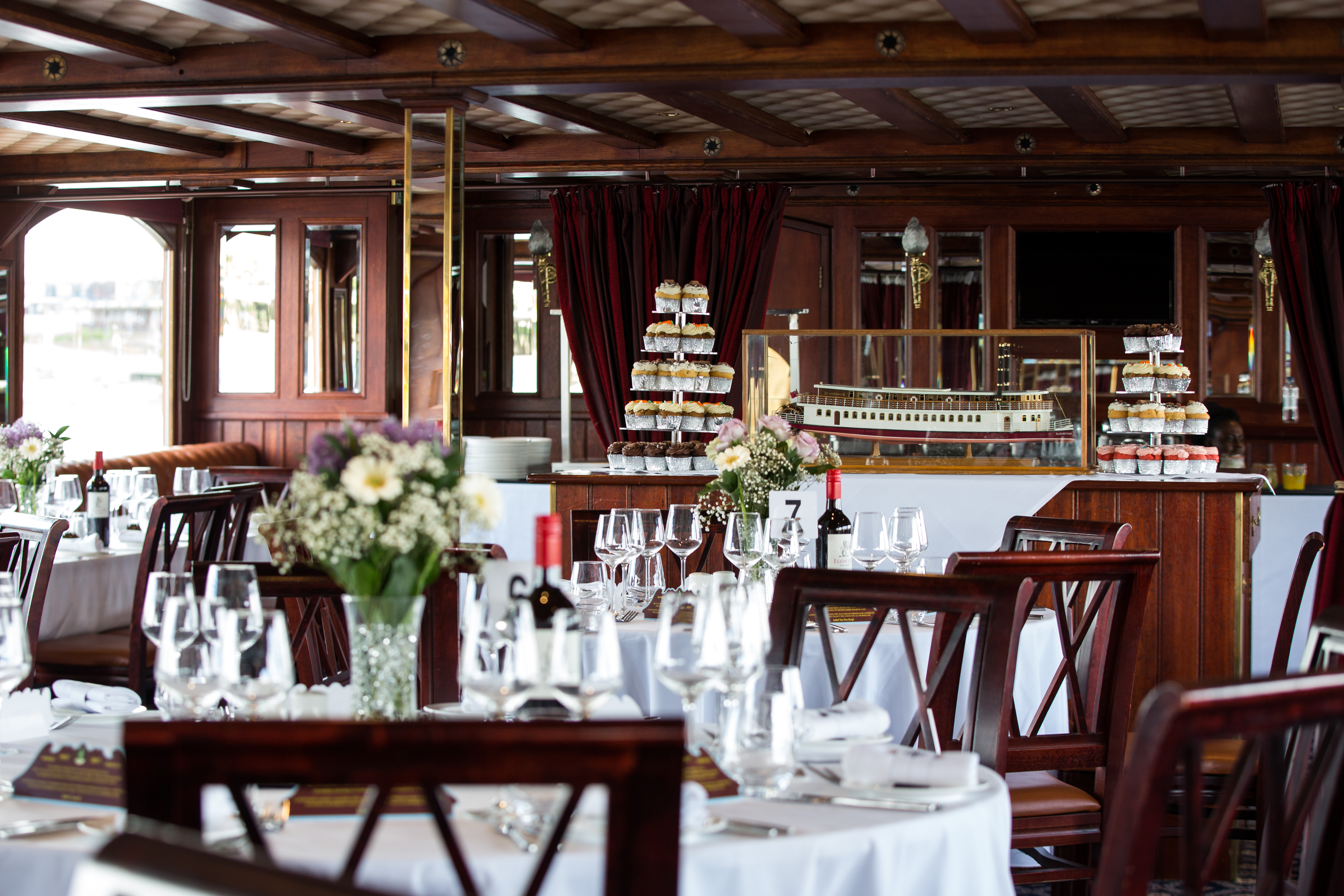 Elegant dining area on a boat, perfect for upscale events and corporate dinners.