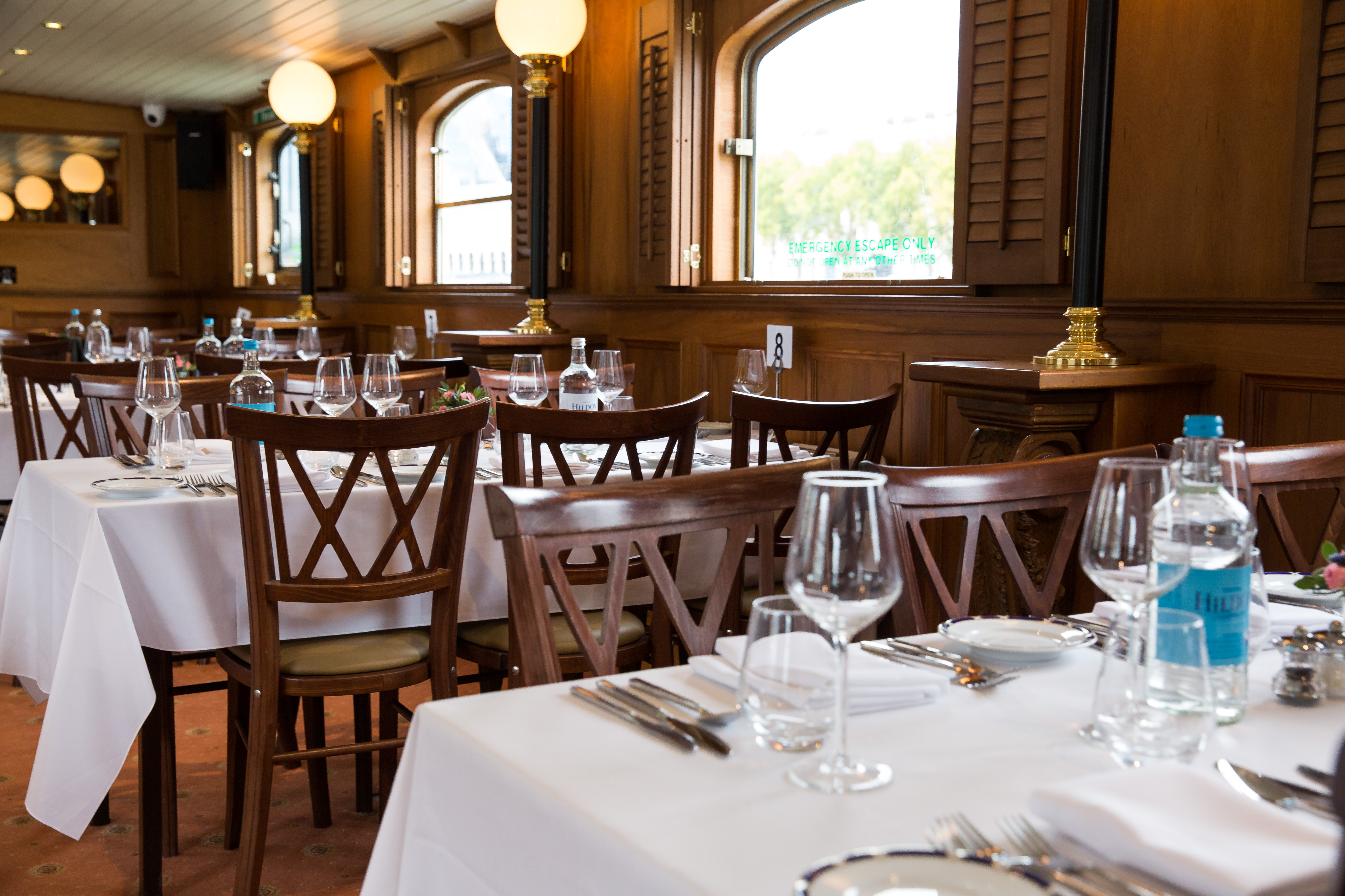 Elegant Edwardian dining venue with warm decor for corporate events and gatherings.