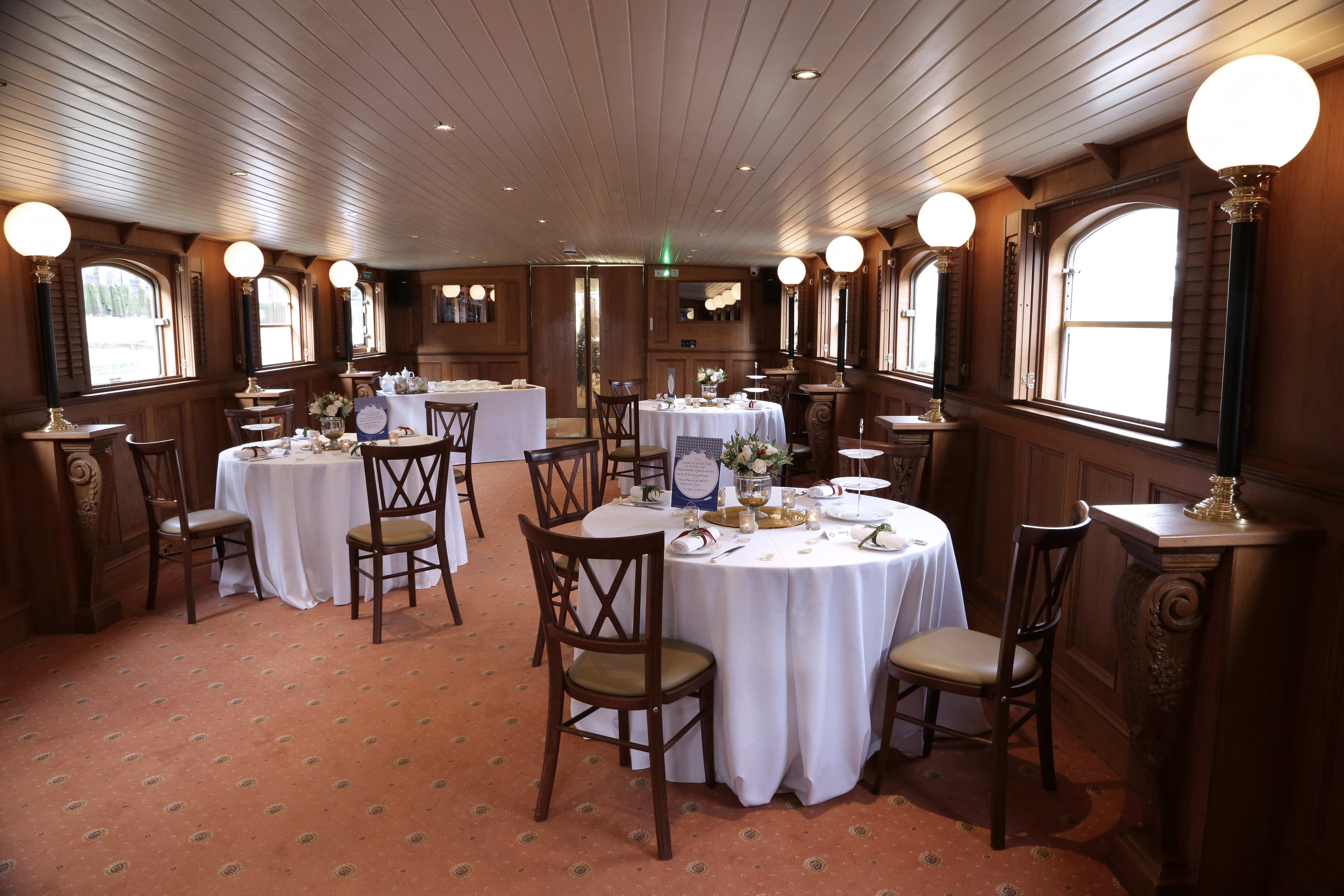 Elegant Edwardian venue with round tables, ideal for corporate events and private celebrations.