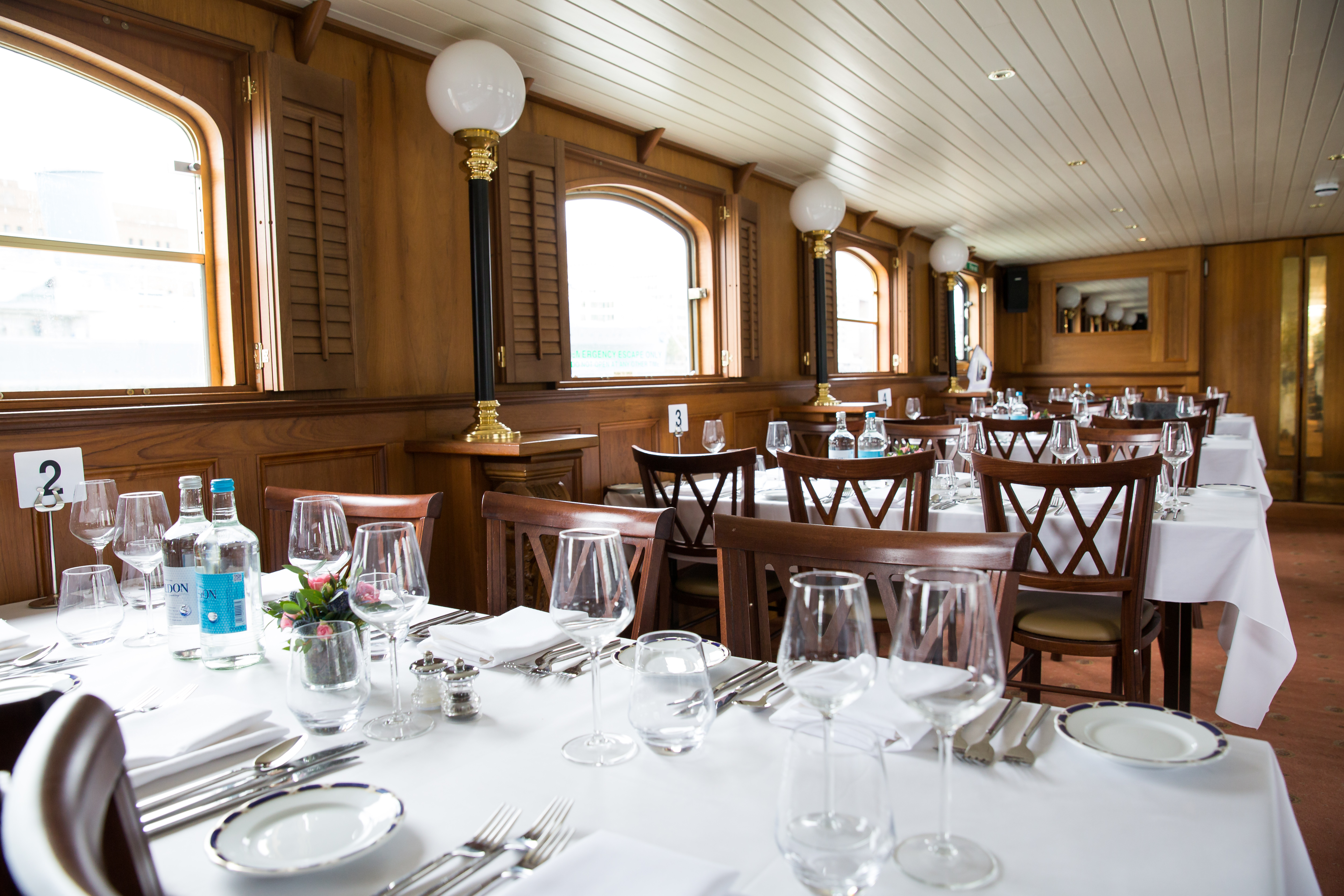 Elegant Edwardian dining area with wooden paneling for upscale events and meetings.