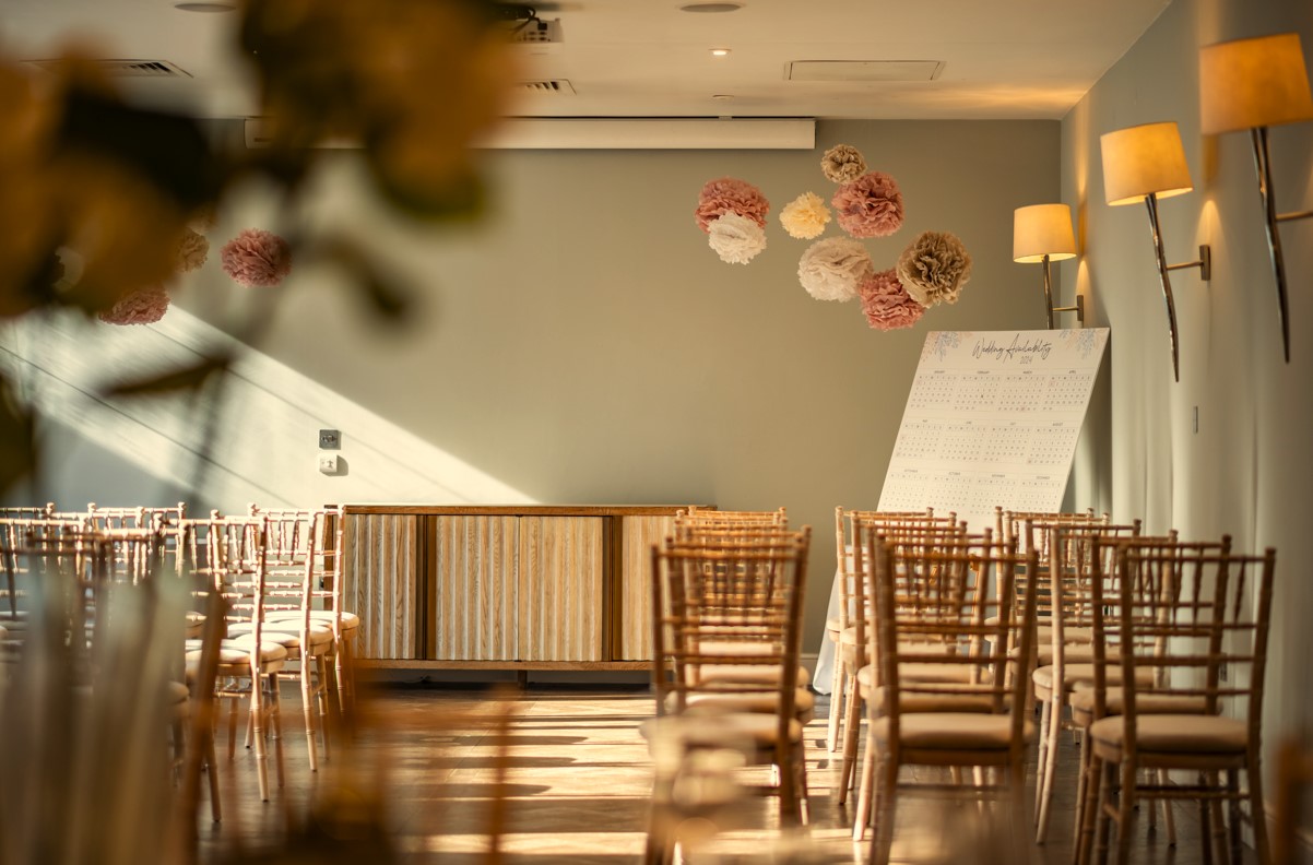 Harbour Suite 1 at Guildford Hotel: elegant meeting space with wooden chairs and whiteboard.