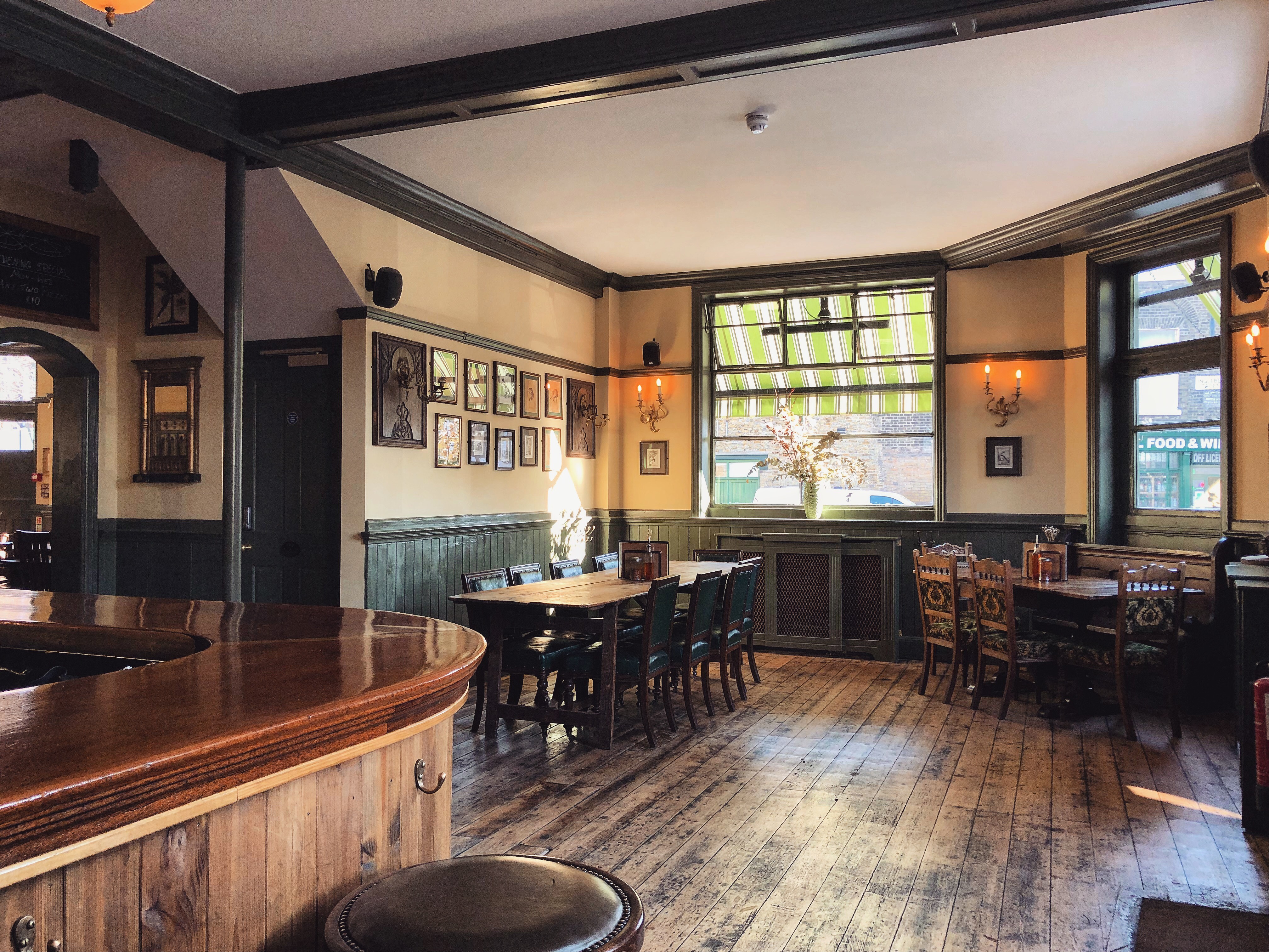 Cozy bar room with warm wood accents, ideal for intimate gatherings and meetings.