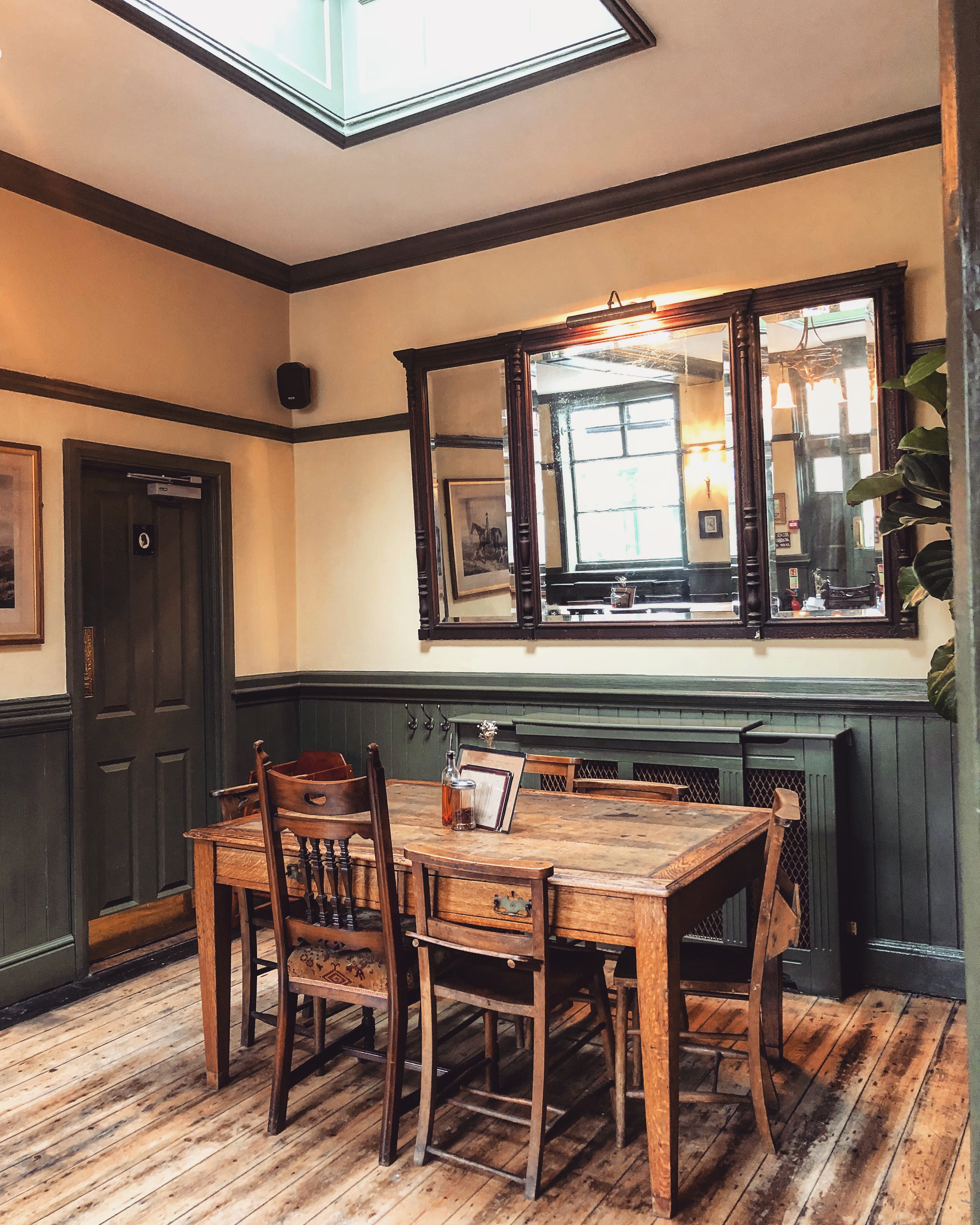 Cozy meeting space with rustic table at The George and Monkey for intimate gatherings.