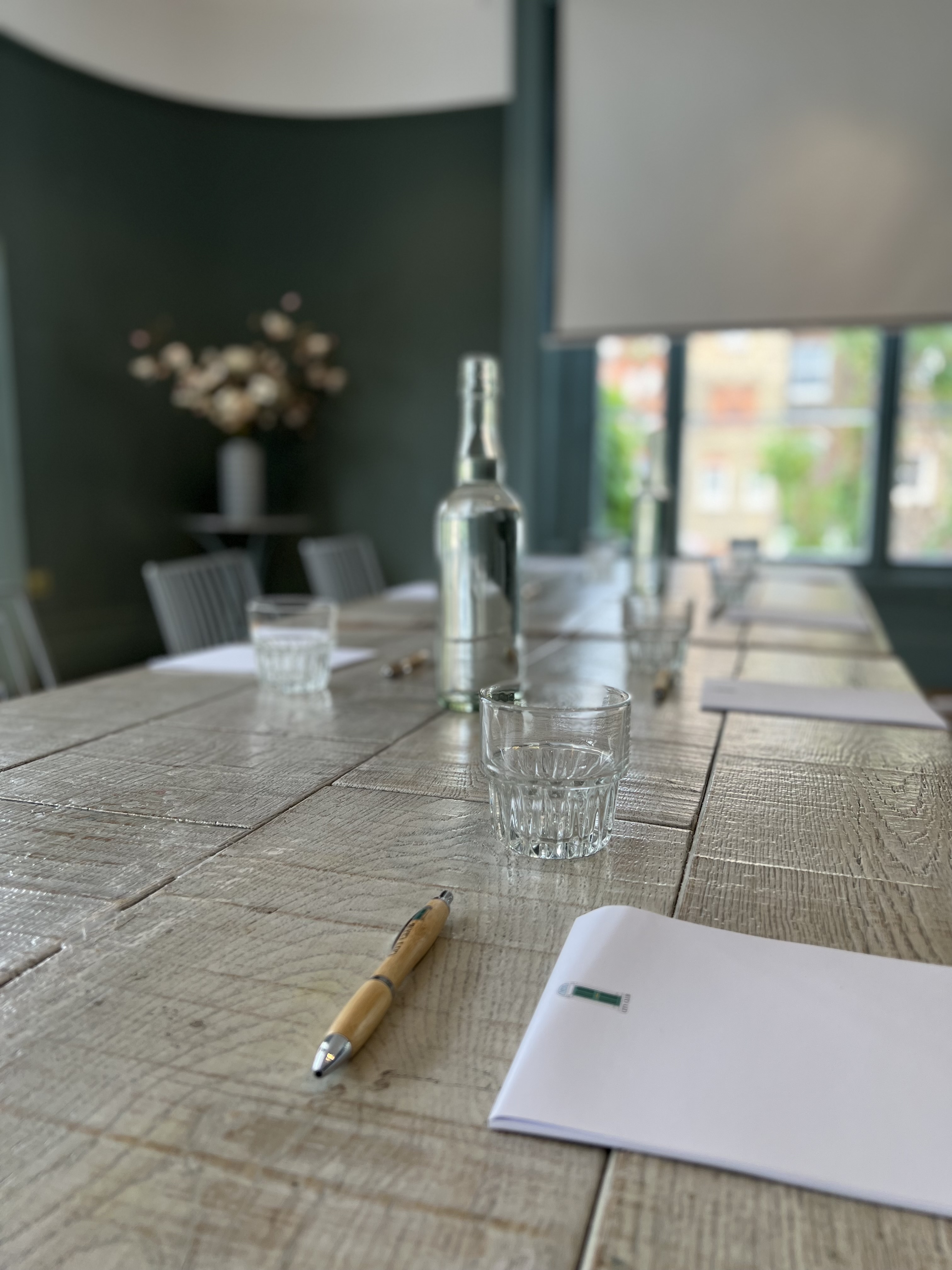 Intimate meeting space with wooden table, ideal for discussions at The Phene Club Room.