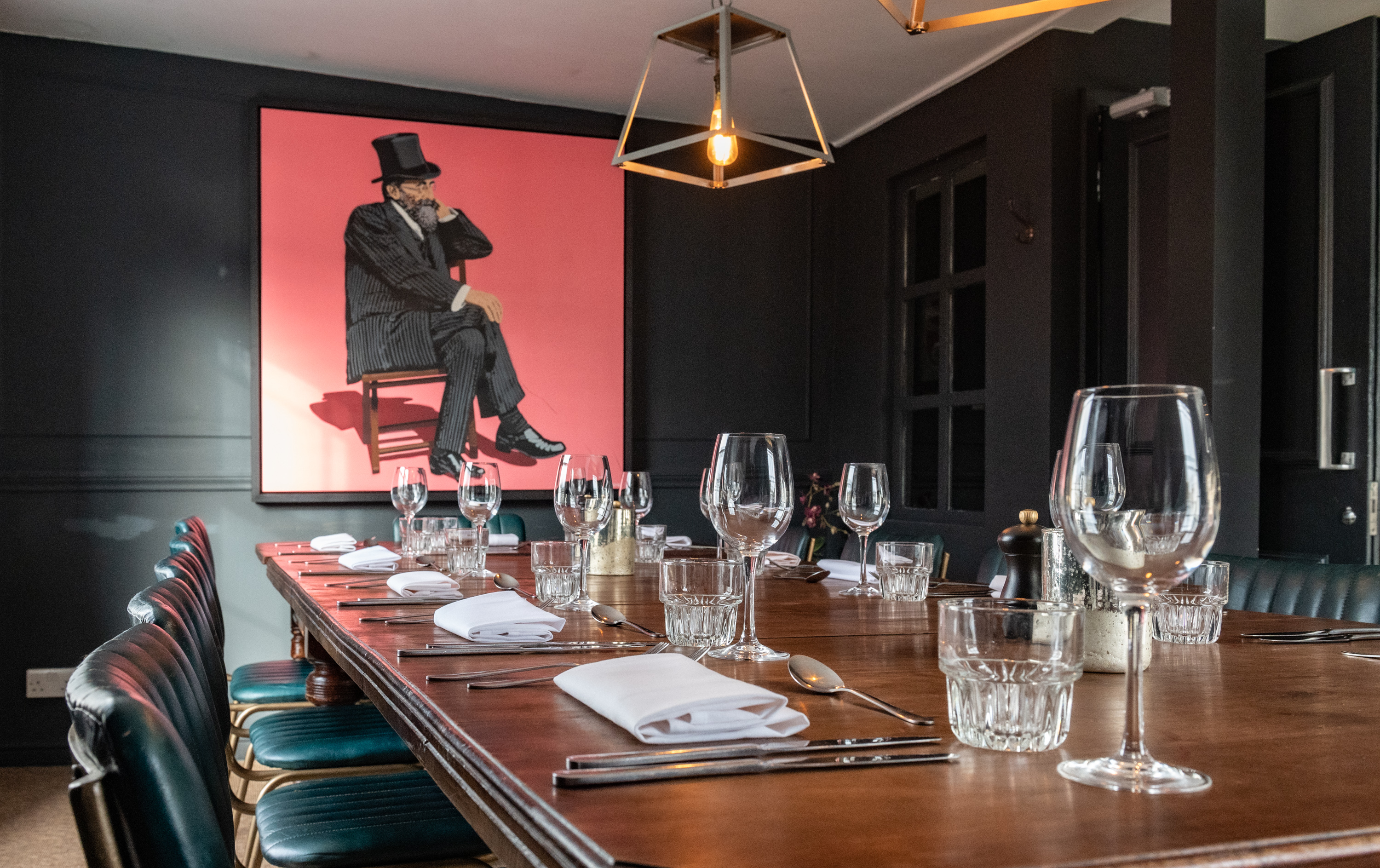 Sophisticated meeting space with wooden table, ideal for intimate gatherings and events.