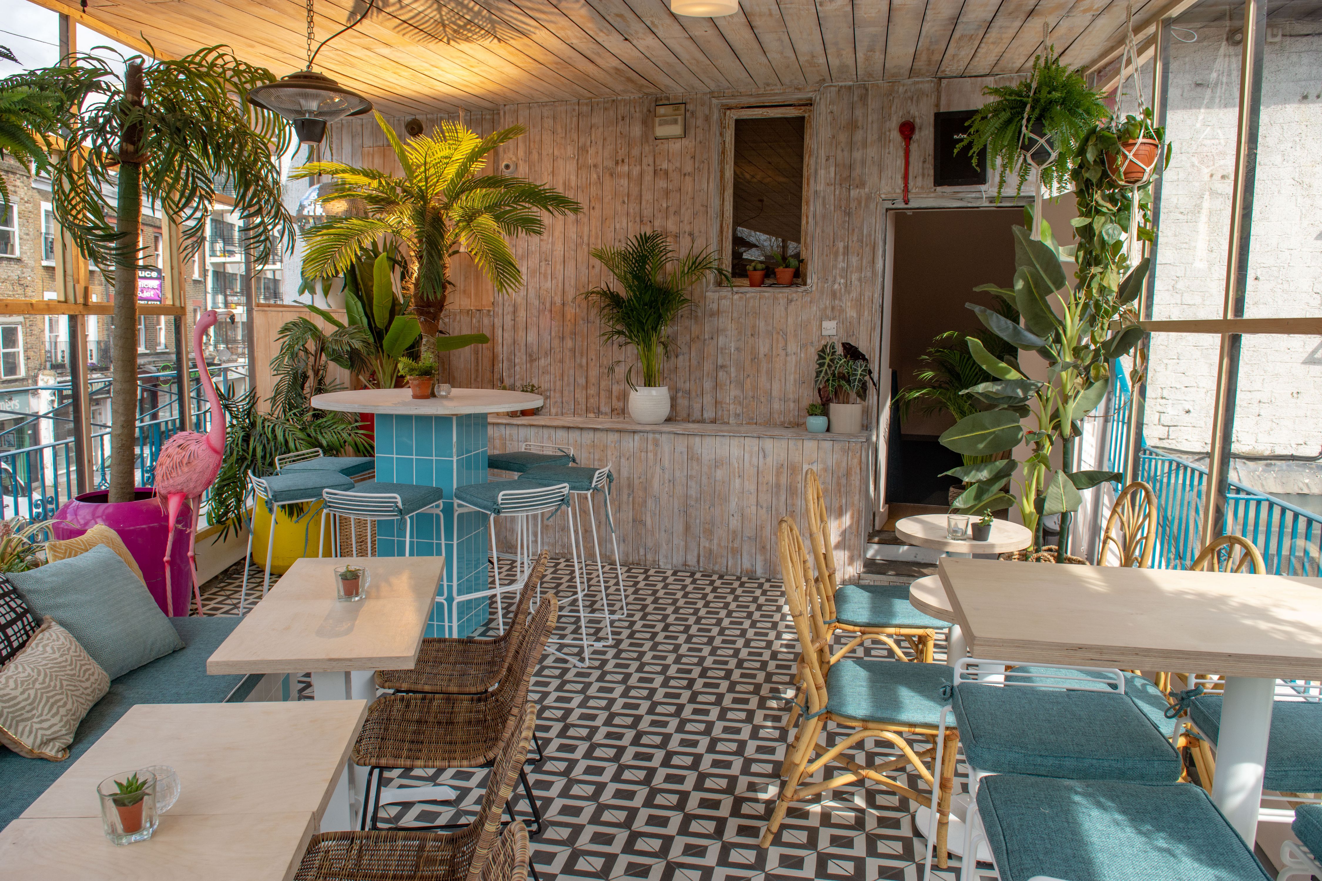 Vibrant event space in Studio 48 with stylish decor and greenery for gatherings.