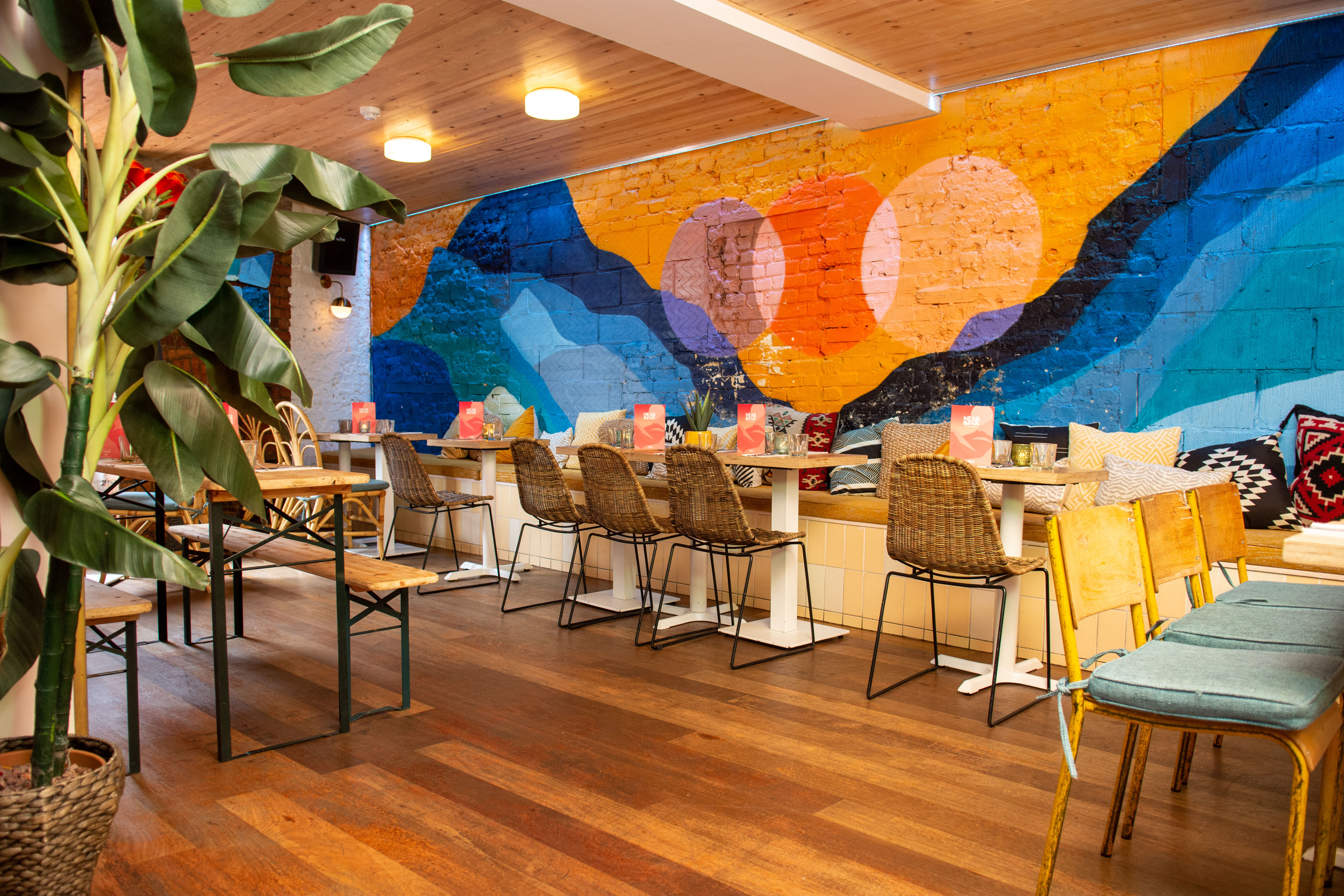 Vibrant event space in Studio 48 with colorful mural, ideal for meetings and gatherings.