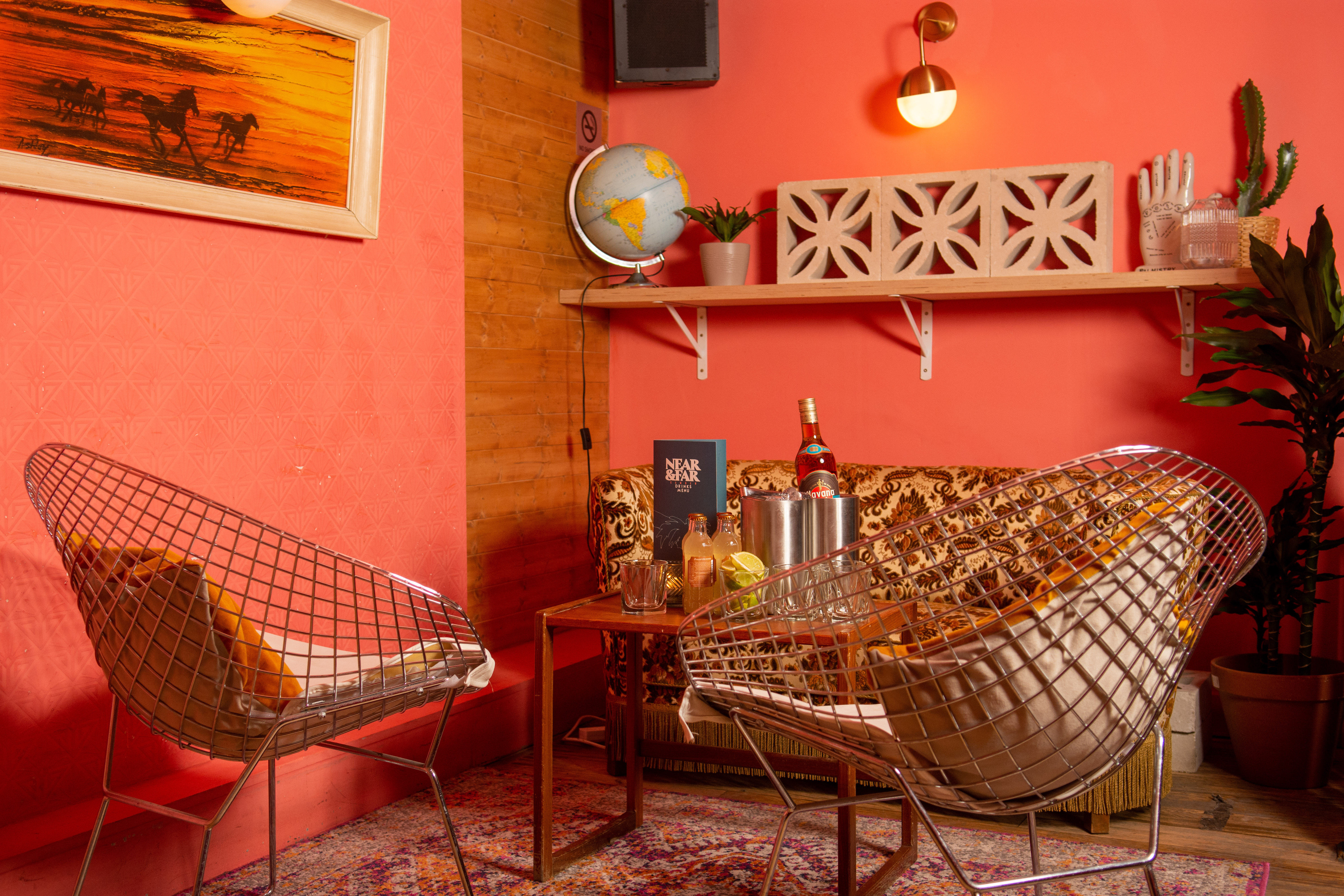 Stylish lounge in Studio 48 with coral walls, ideal for networking events and meetings.