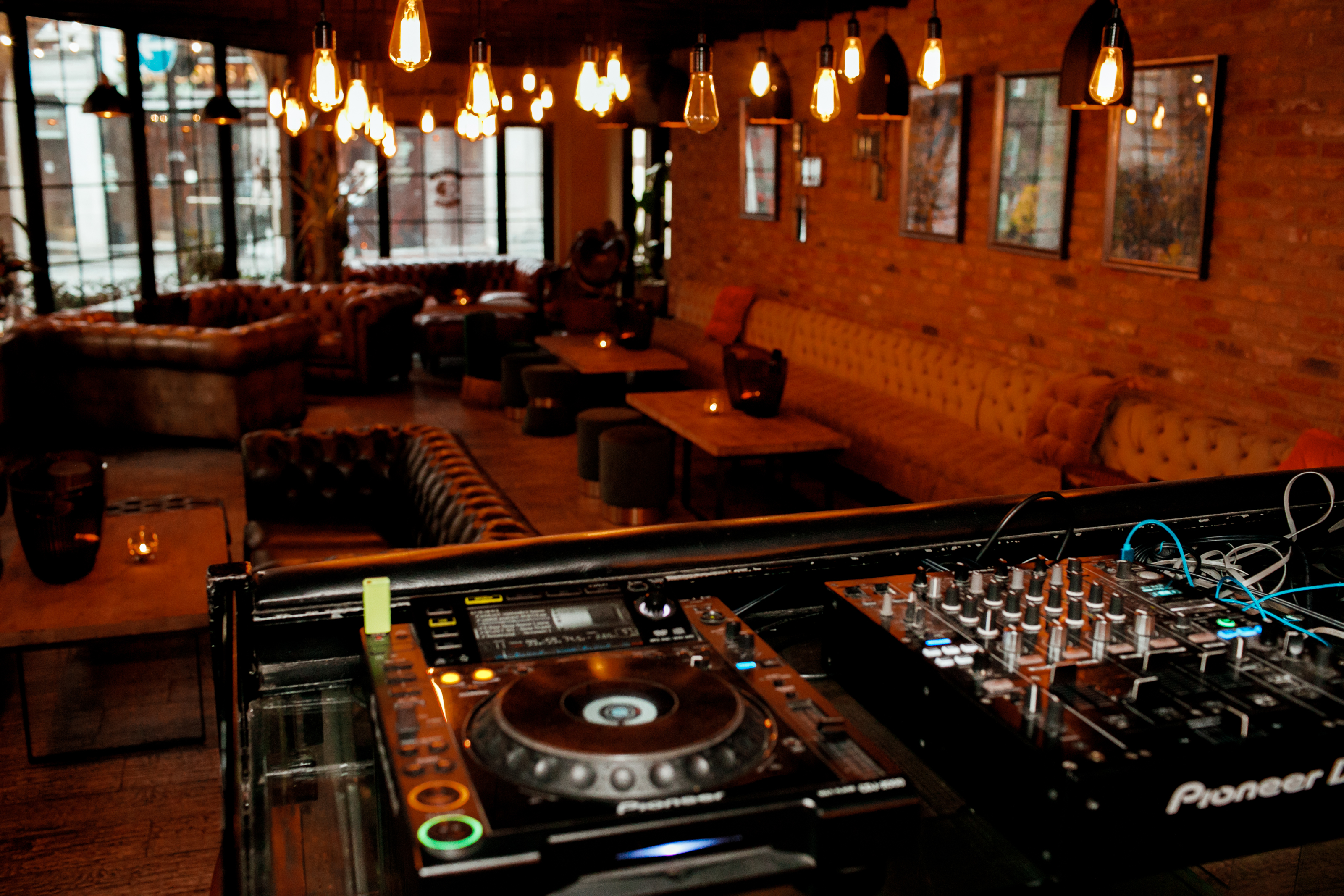 Stylish Wilfred's Lounge in Mayfair, perfect for events with cozy lighting and DJ setup.