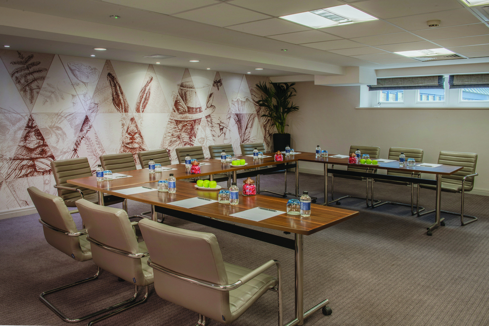 De Vere Tortworth Court meeting room with U-shaped tables for professional events.