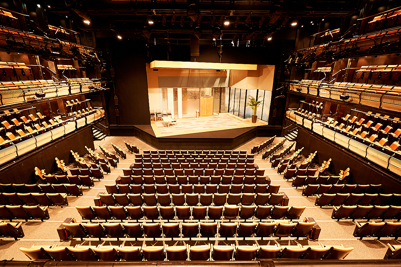 Bridge Theatre auditorium with tiered seating, perfect for conferences and performances.