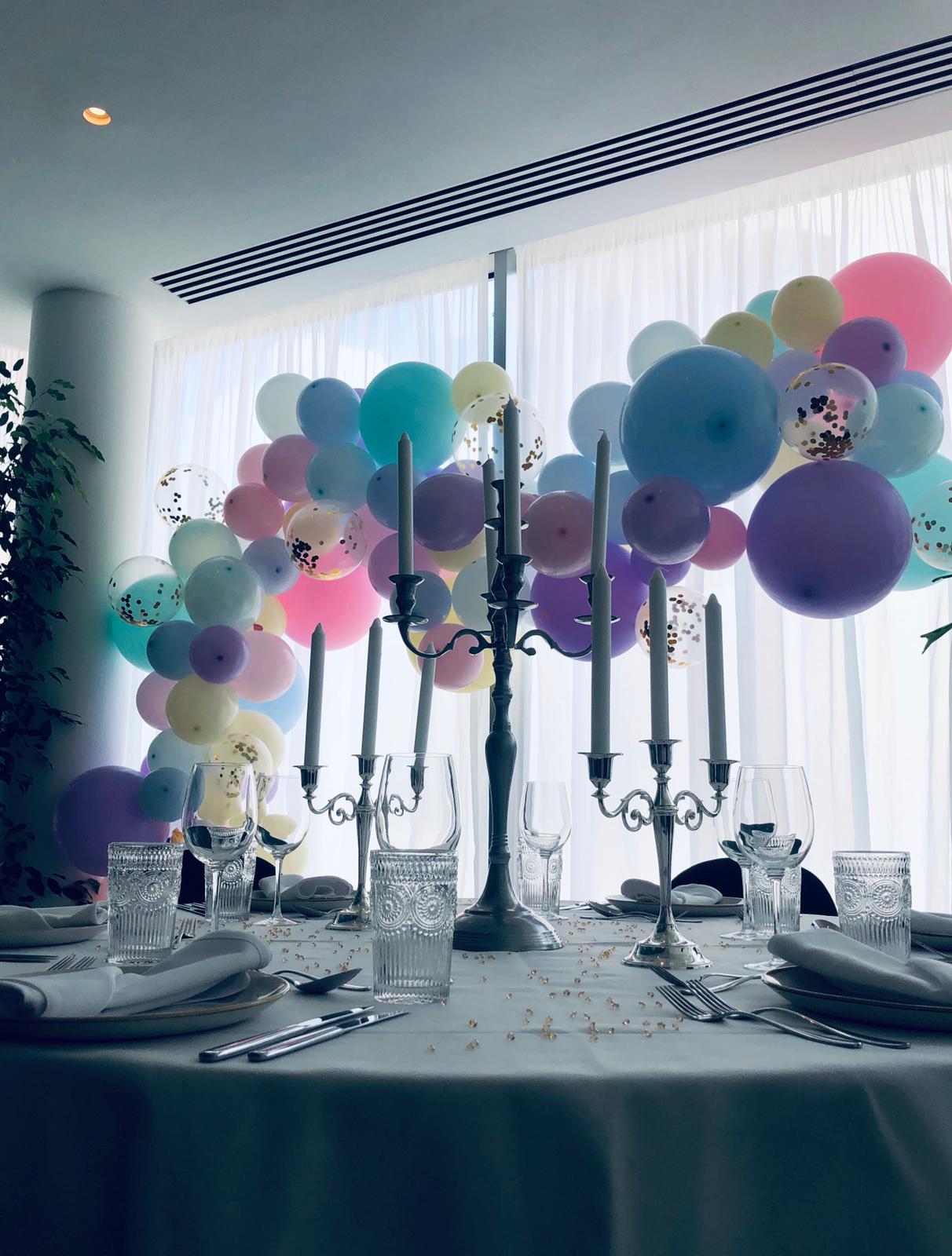 Elegant event space at Whitechapel Think Factory with pastel balloon arch and crystal decor.