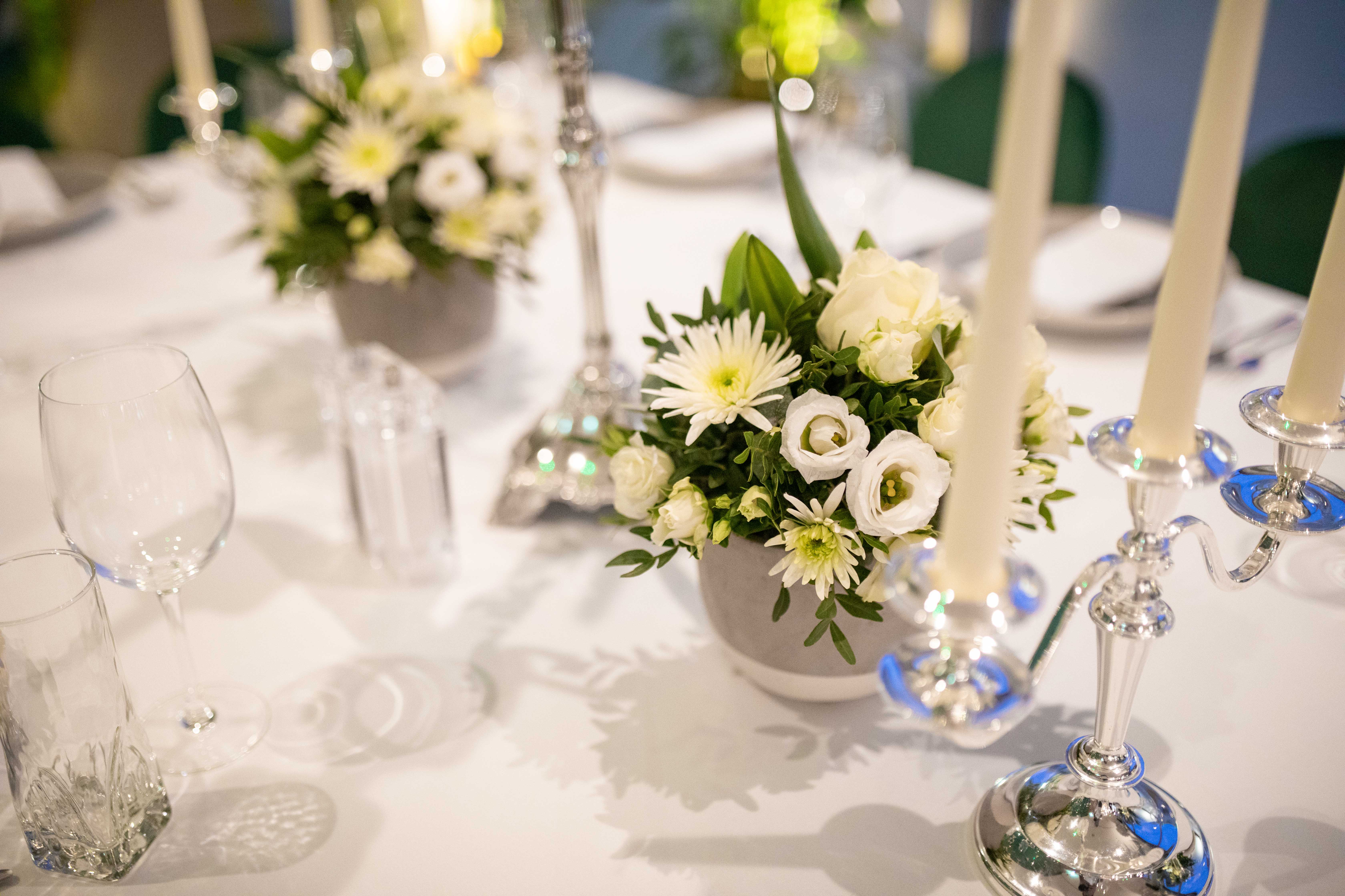 Elegant dining table with floral centerpieces for a formal gala at Whitechapel Think Factory.