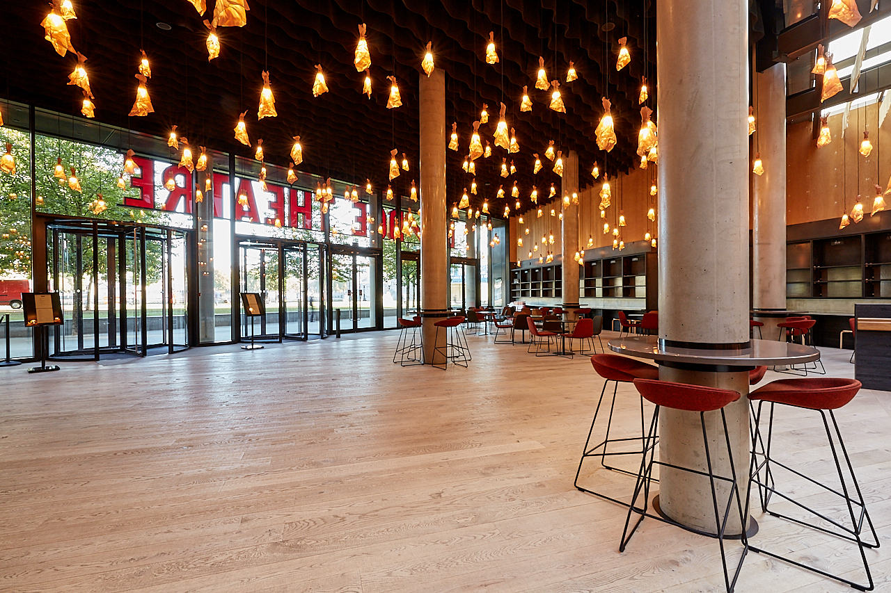 Main Foyer at Bridge Theatre: modern event space with pendant lighting for networking events.