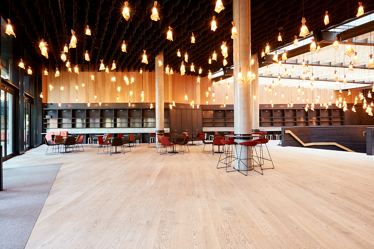 Main Foyer at Bridge Theatre: modern event space with warm wood accents and flexible seating.