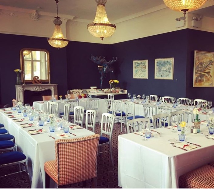 Elegant Lillie Lounge event space with floral centerpieces, ideal for gatherings and meetings.