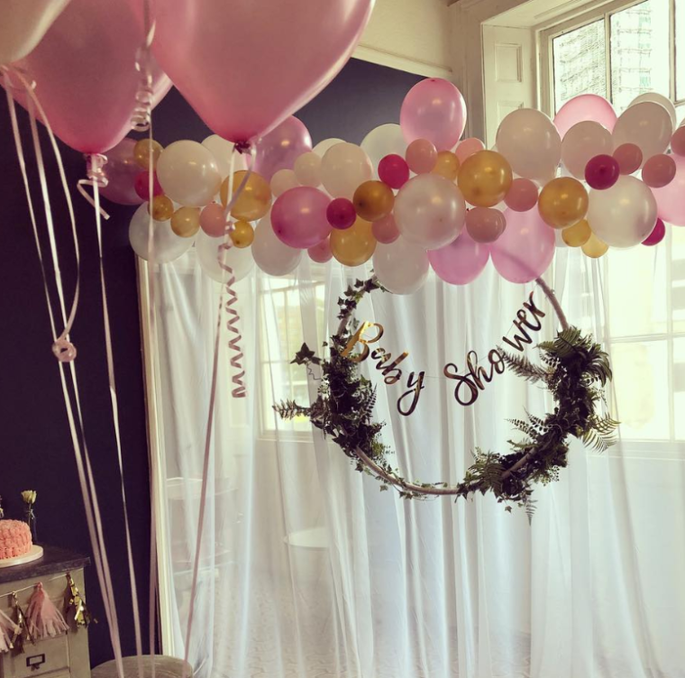Baby shower setup at The Lillie Lounge with vibrant pink balloon arch and elegant decor.