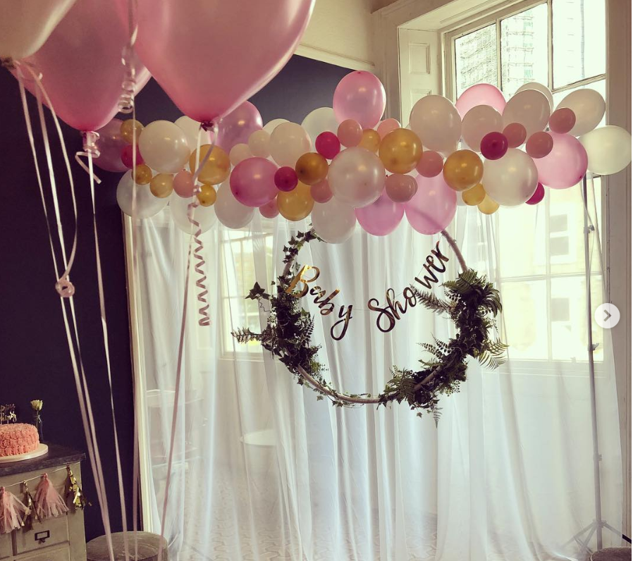 Baby shower event space with balloon arch in The Lillie Lounge, elegant decor.