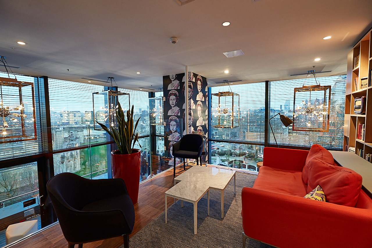 Modern meeting space in cloudM Tower, London with panoramic city views and vibrant decor.