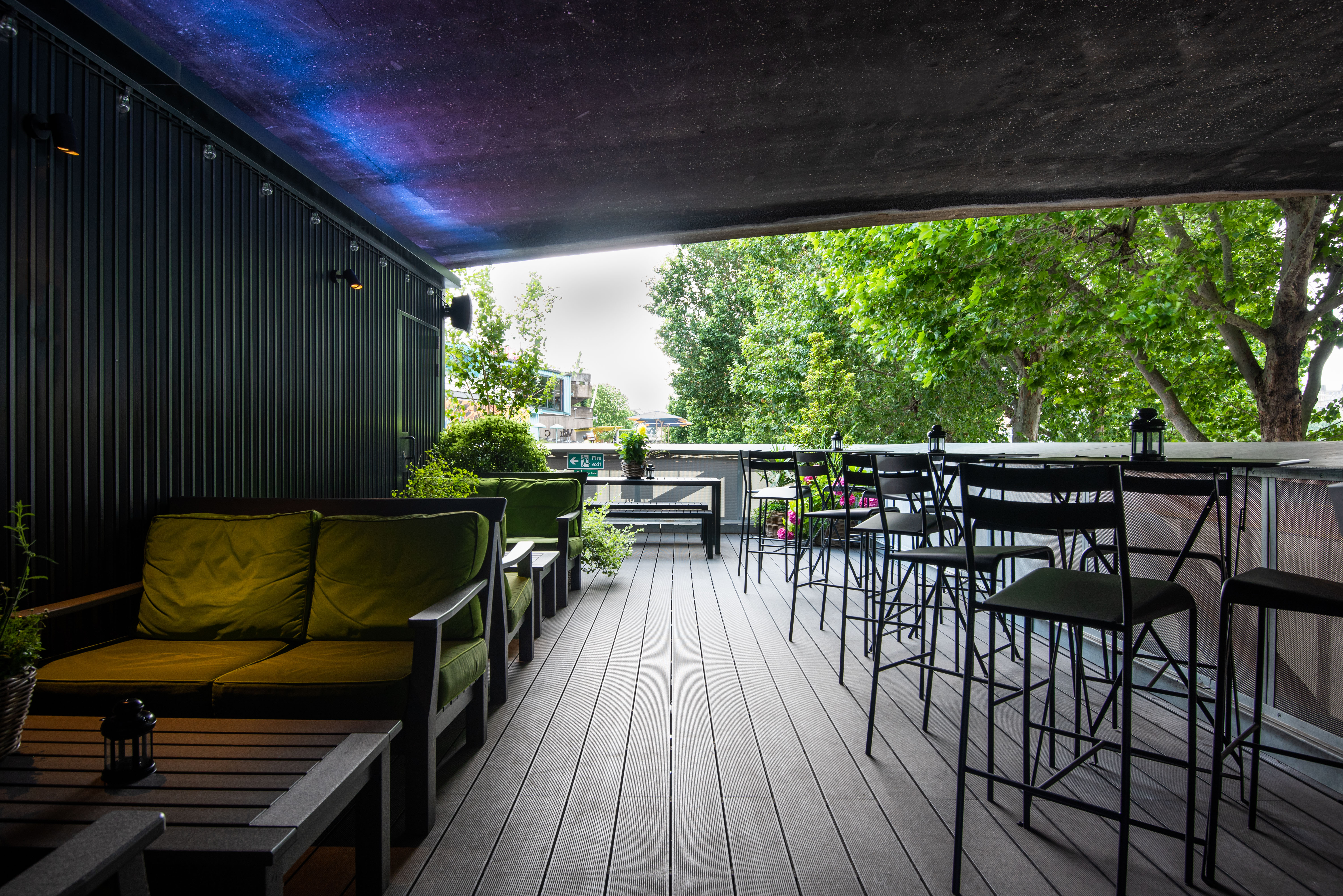 Stylish outdoor event space at Balcony Bar with greenery, ideal for cocktail receptions.