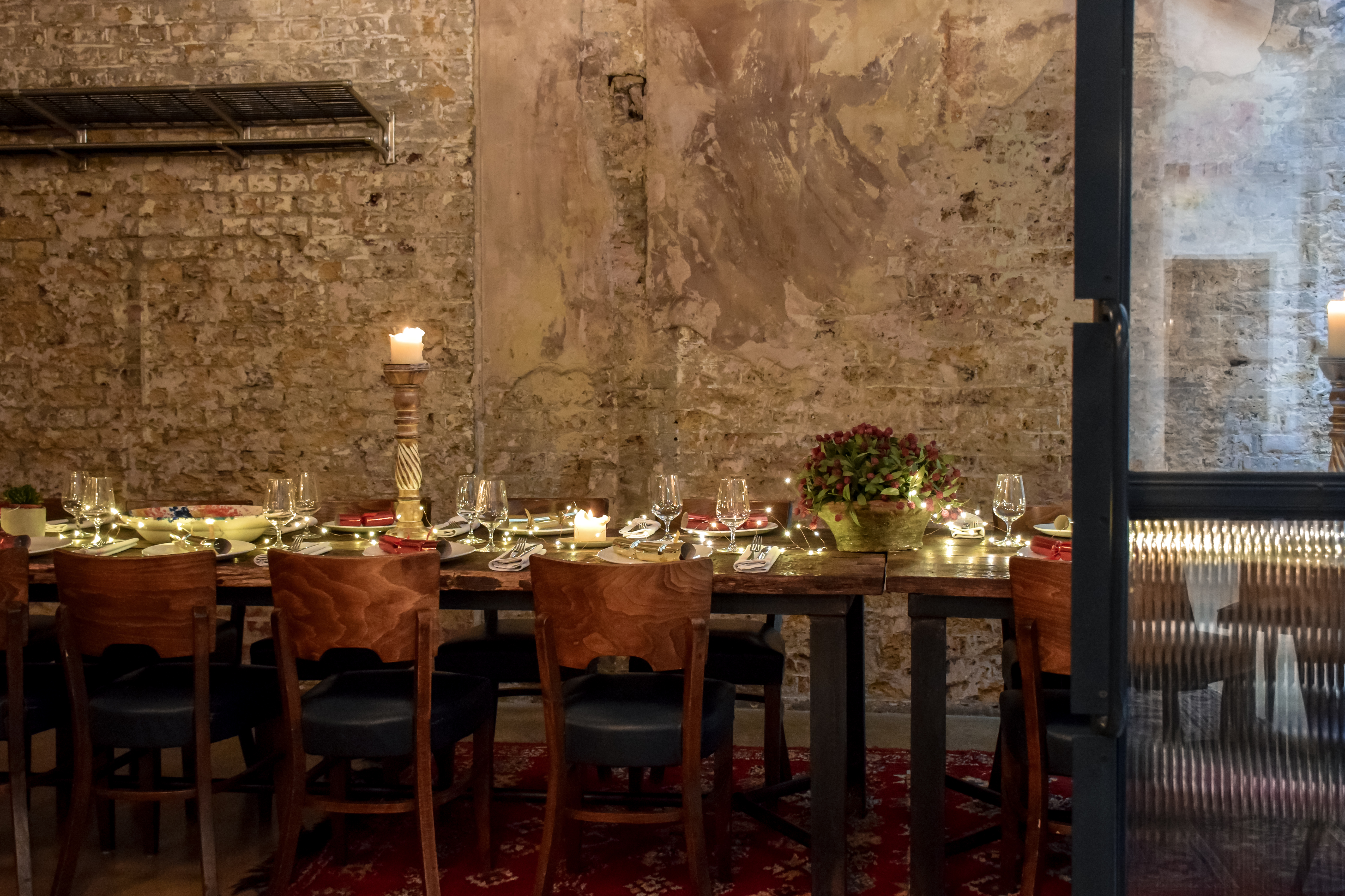Intimate private dining room with elegant table setting for corporate events or celebrations.