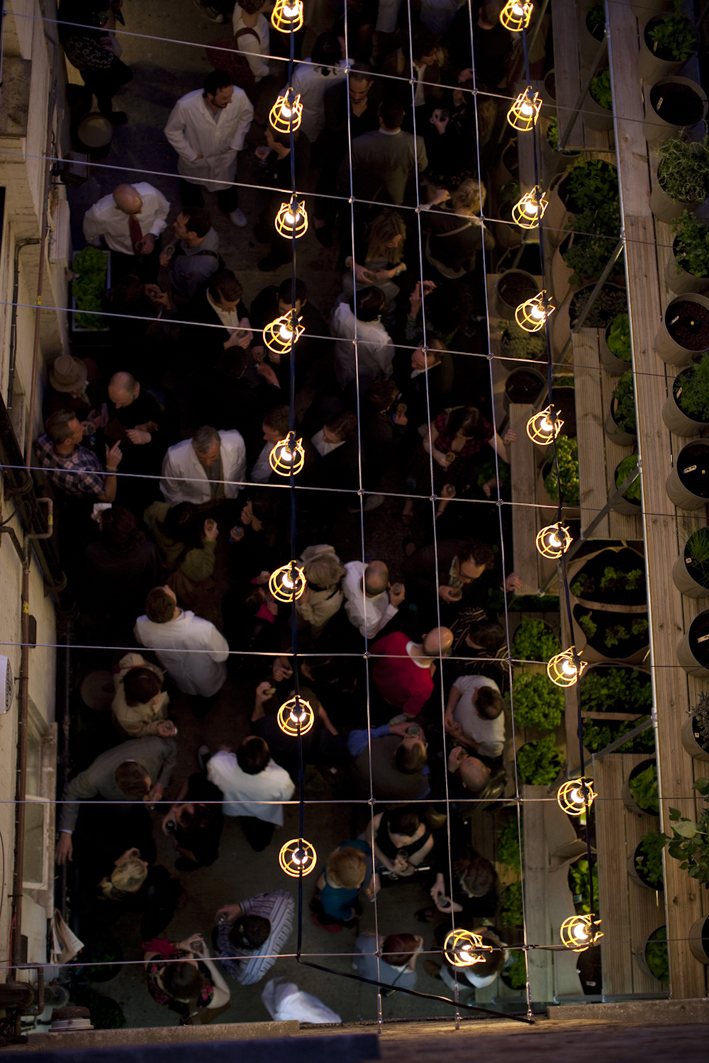 Lively networking event in a greenery-filled courtyard at The Future Laboratory.