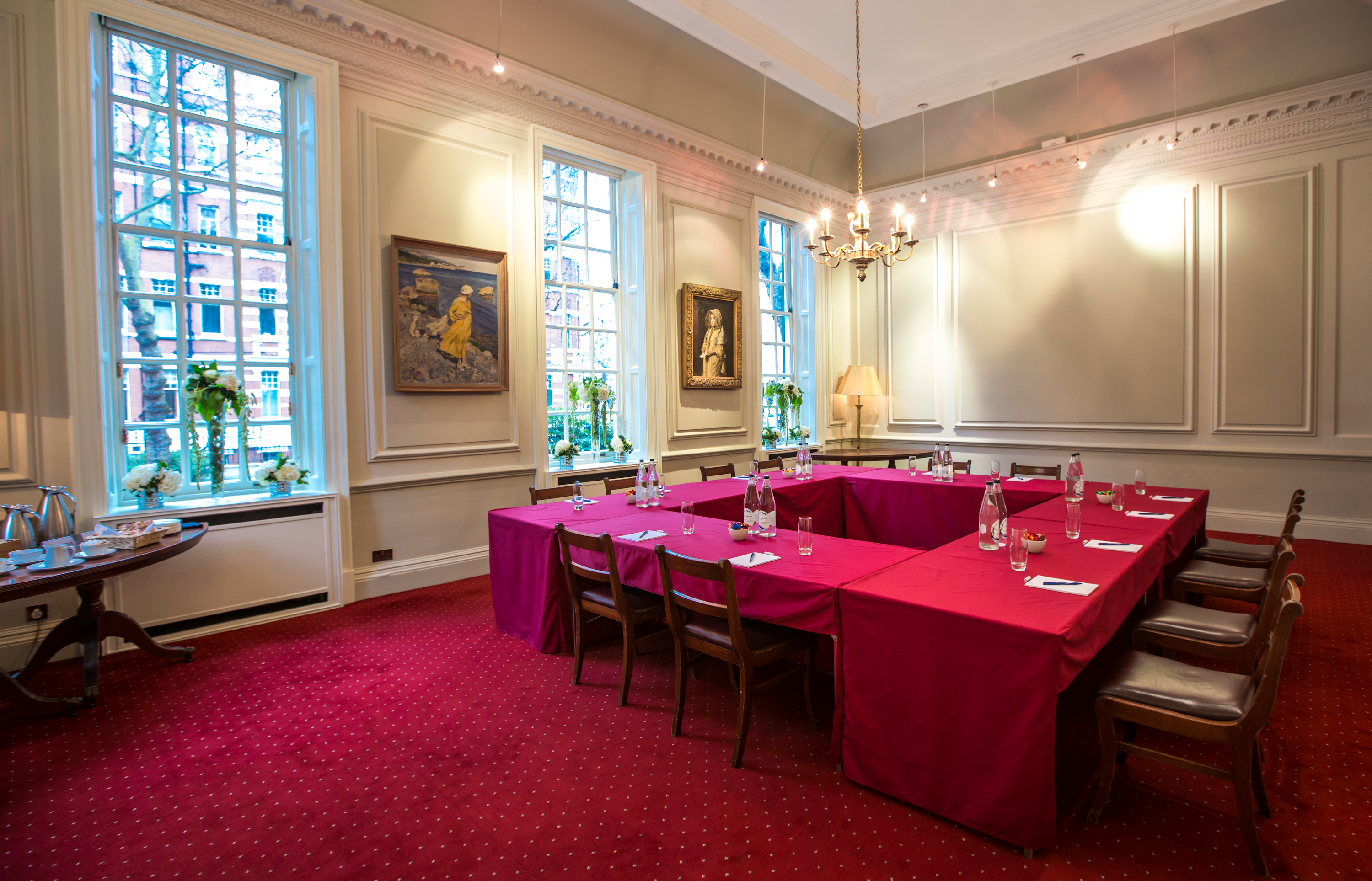 The Drawing Room at Imperial Venues, featuring a burgundy table for meetings and workshops.